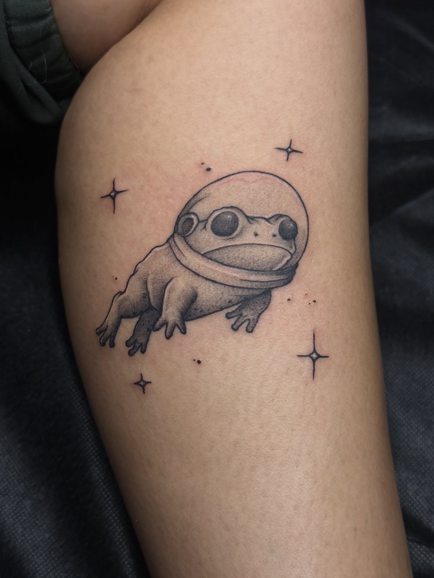 Frog astronaut dotwork tattoo on the forearm by Marcus