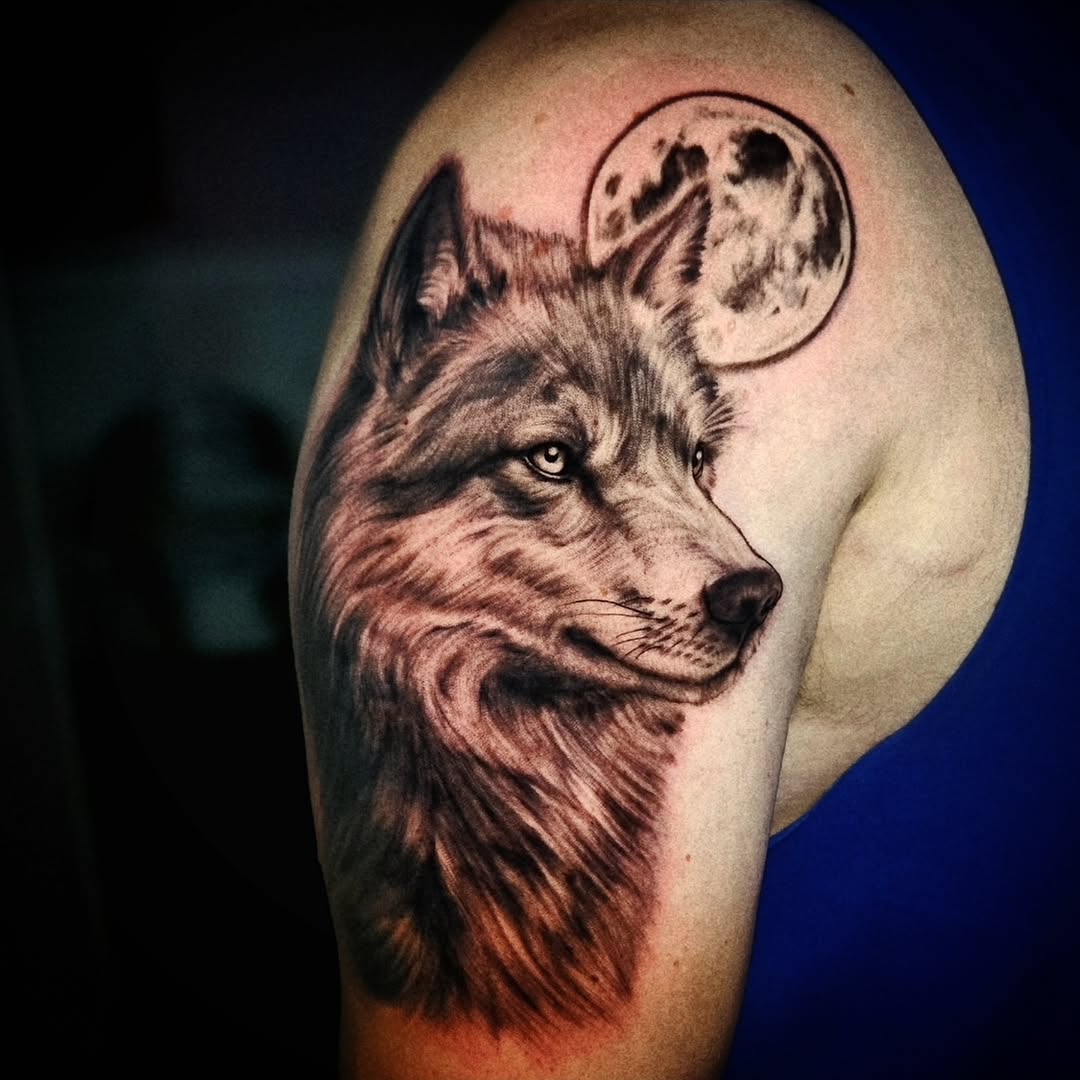 Wolf and moon realism tattoo on the shoulder by Isaac Morales