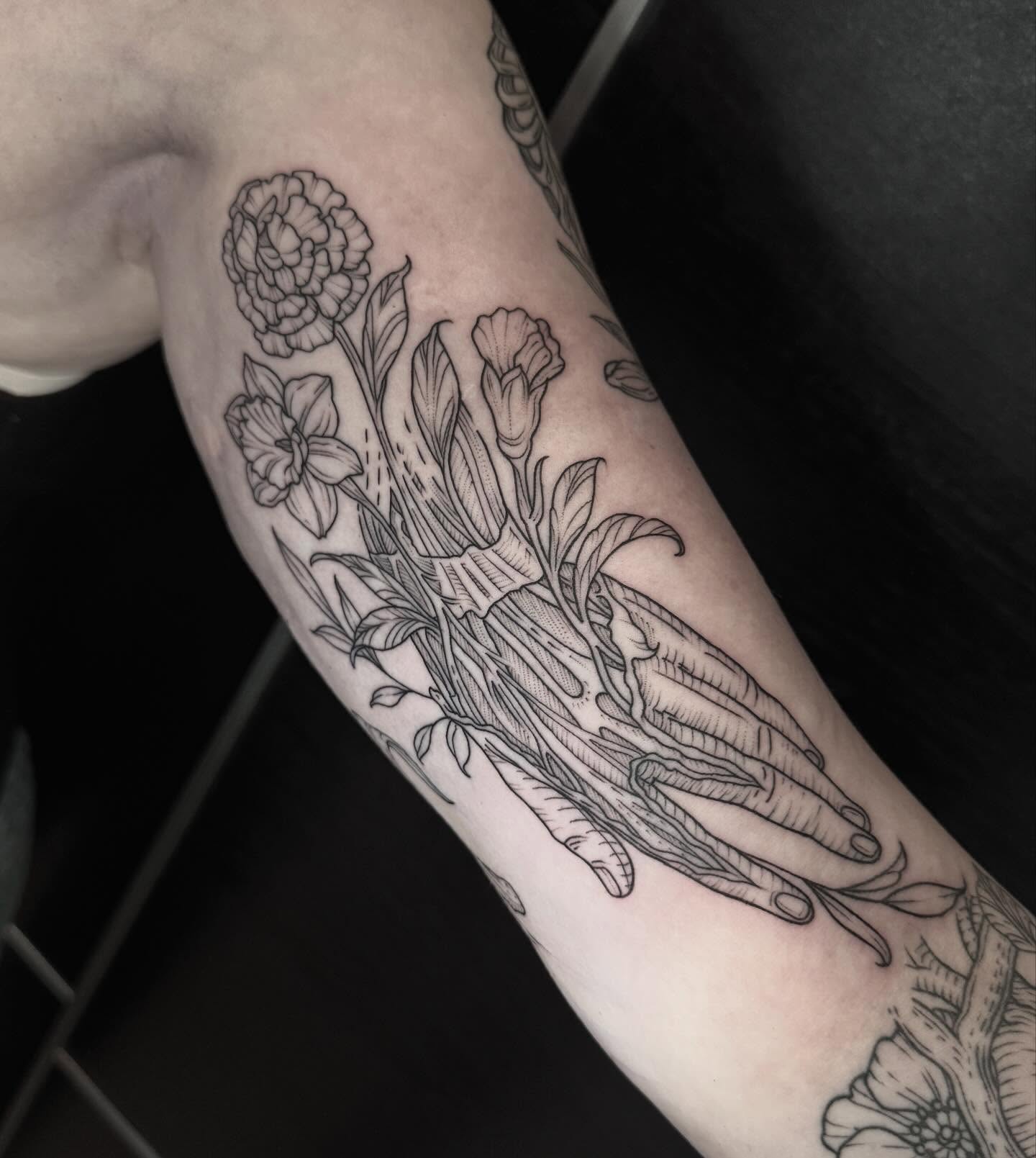 Floral arrangement black and grey tattoo on the forearm by Kirsten Marsden Ballantyne