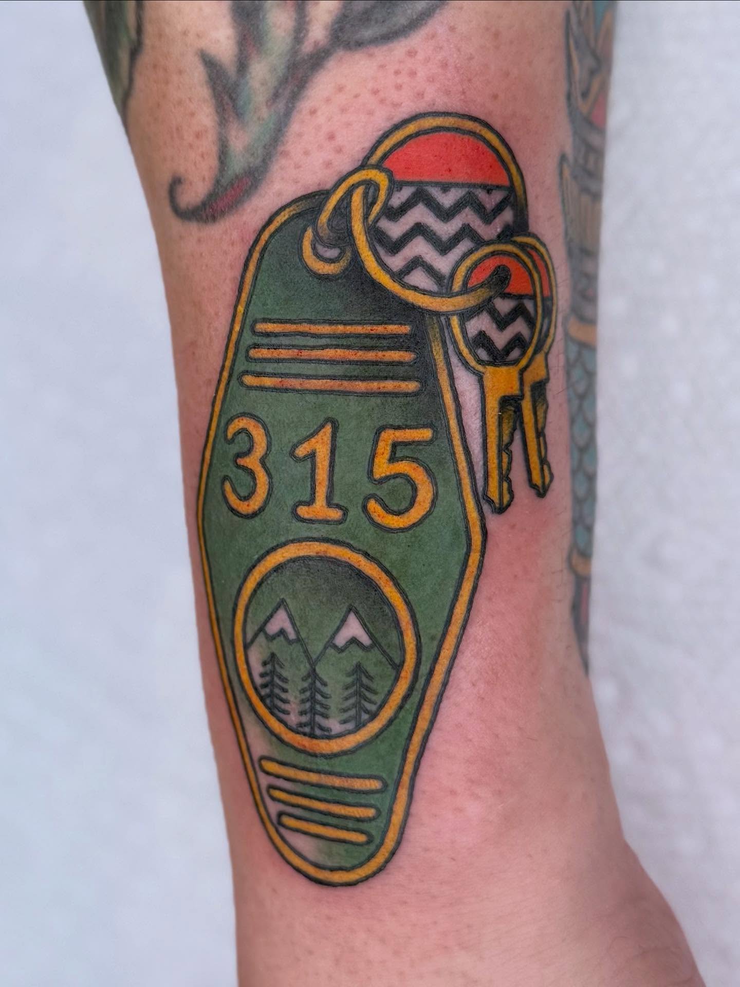 Motel key American traditional tattoo on the forearm by Curtis Stairs, Seattle, Washington