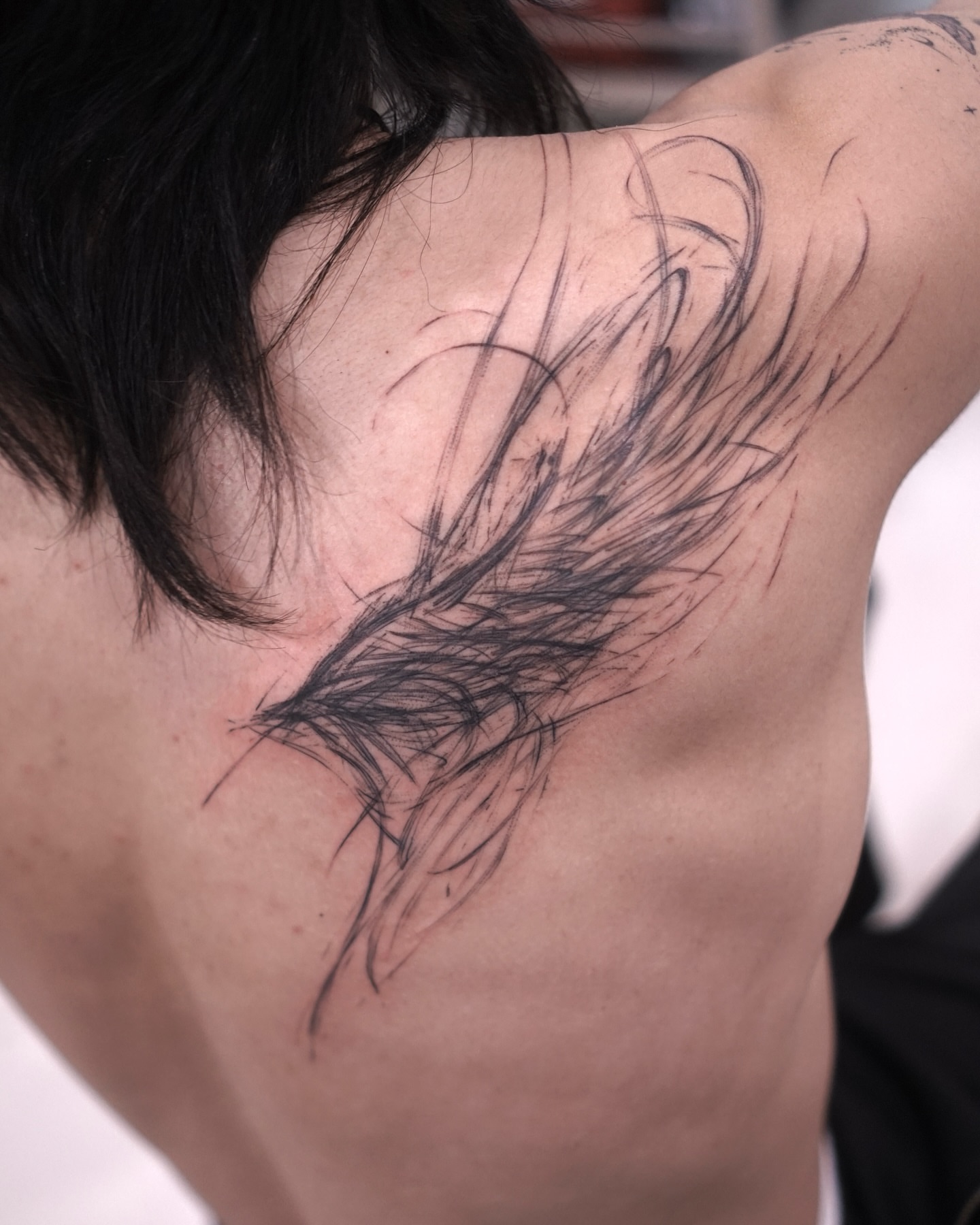 Feather black and grey tattoo on the shoulder by Young one 영원