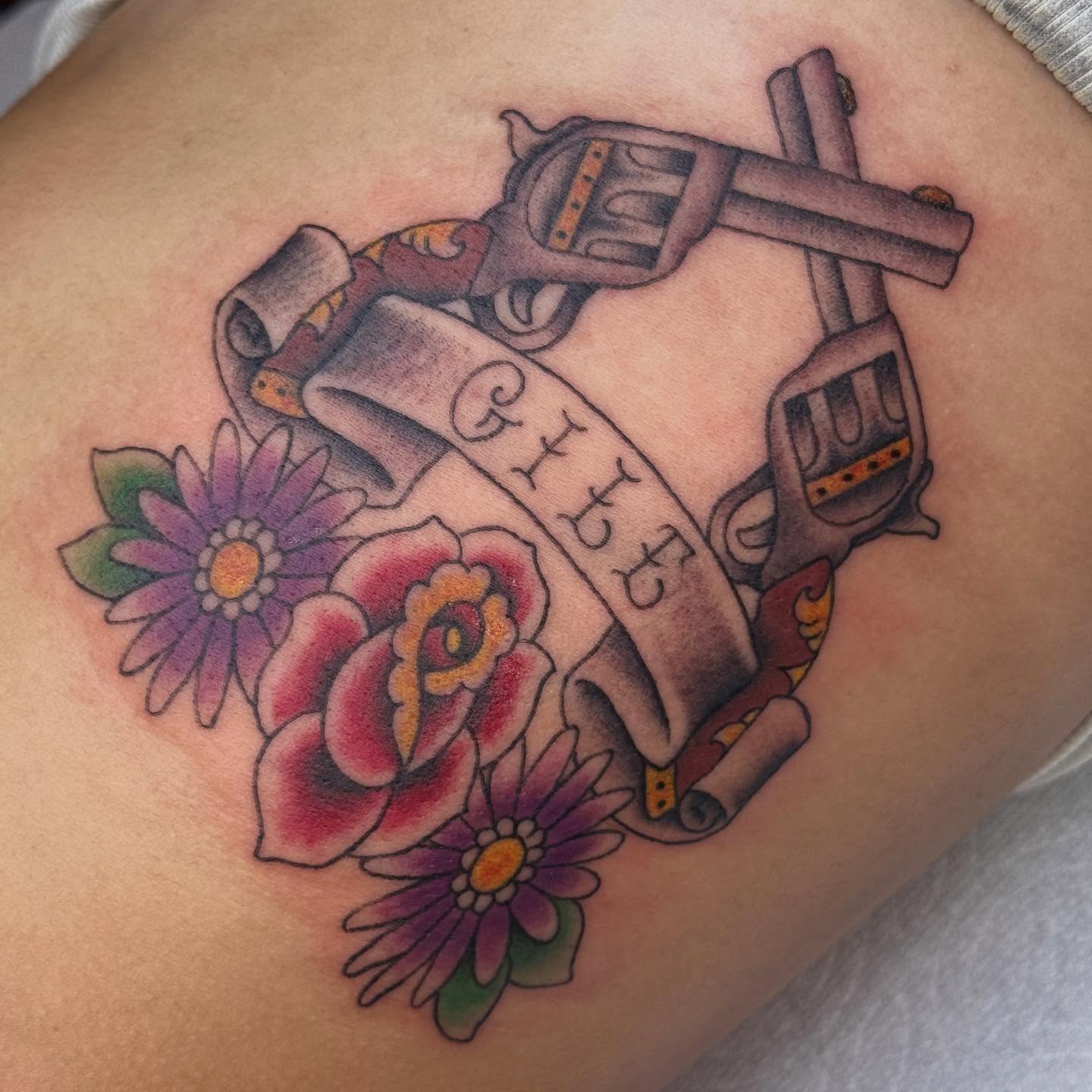 Revolver and scroll American traditional tattoo on the thigh by chloe jeanel estrada