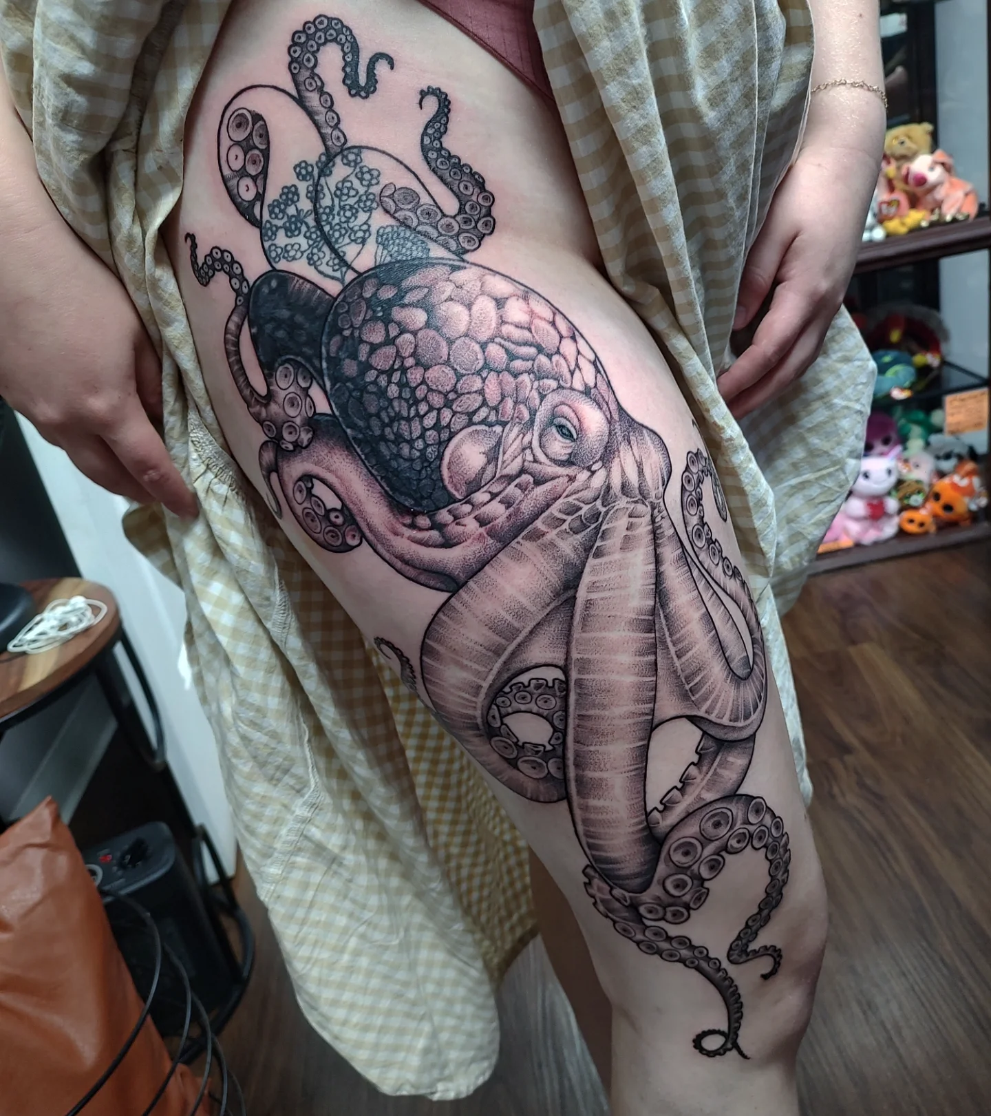 Octopus realism tattoo on the thigh by Jennifer Fowler
