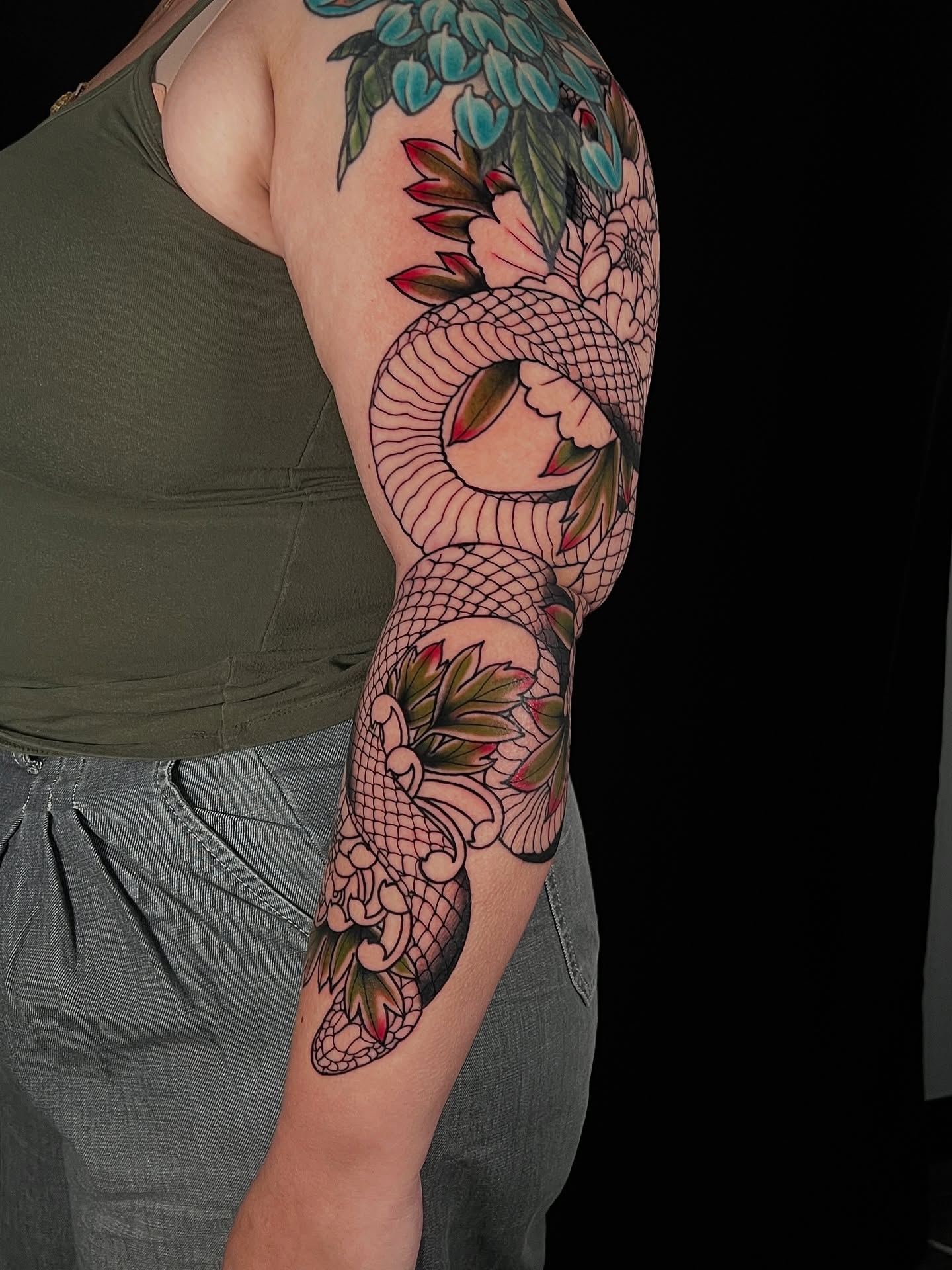 Snake and peony American traditional tattoo on the forearm by Raul Ortiz