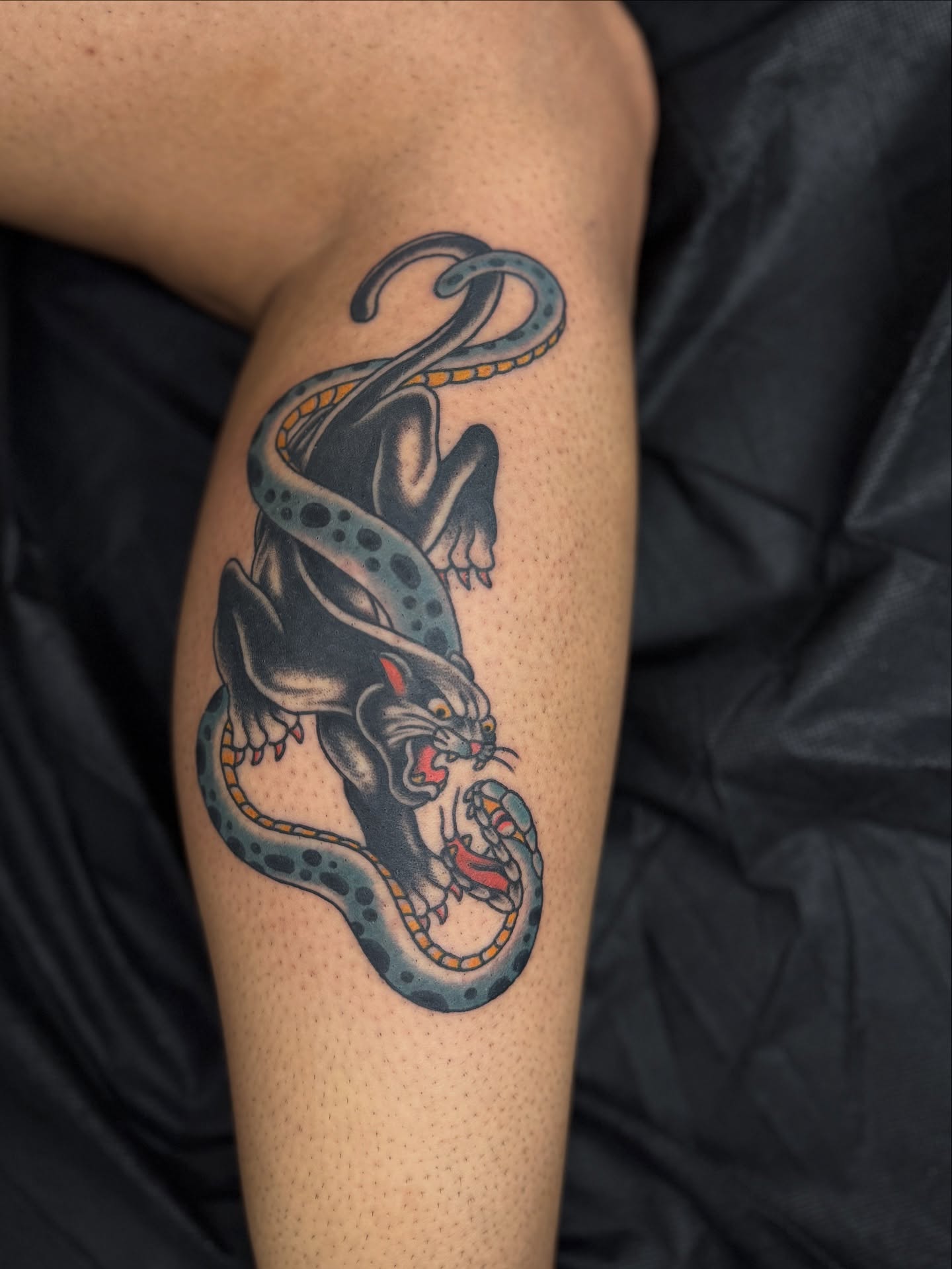 Panther and snake American traditional tattoo on the thigh by Sarah Pham
