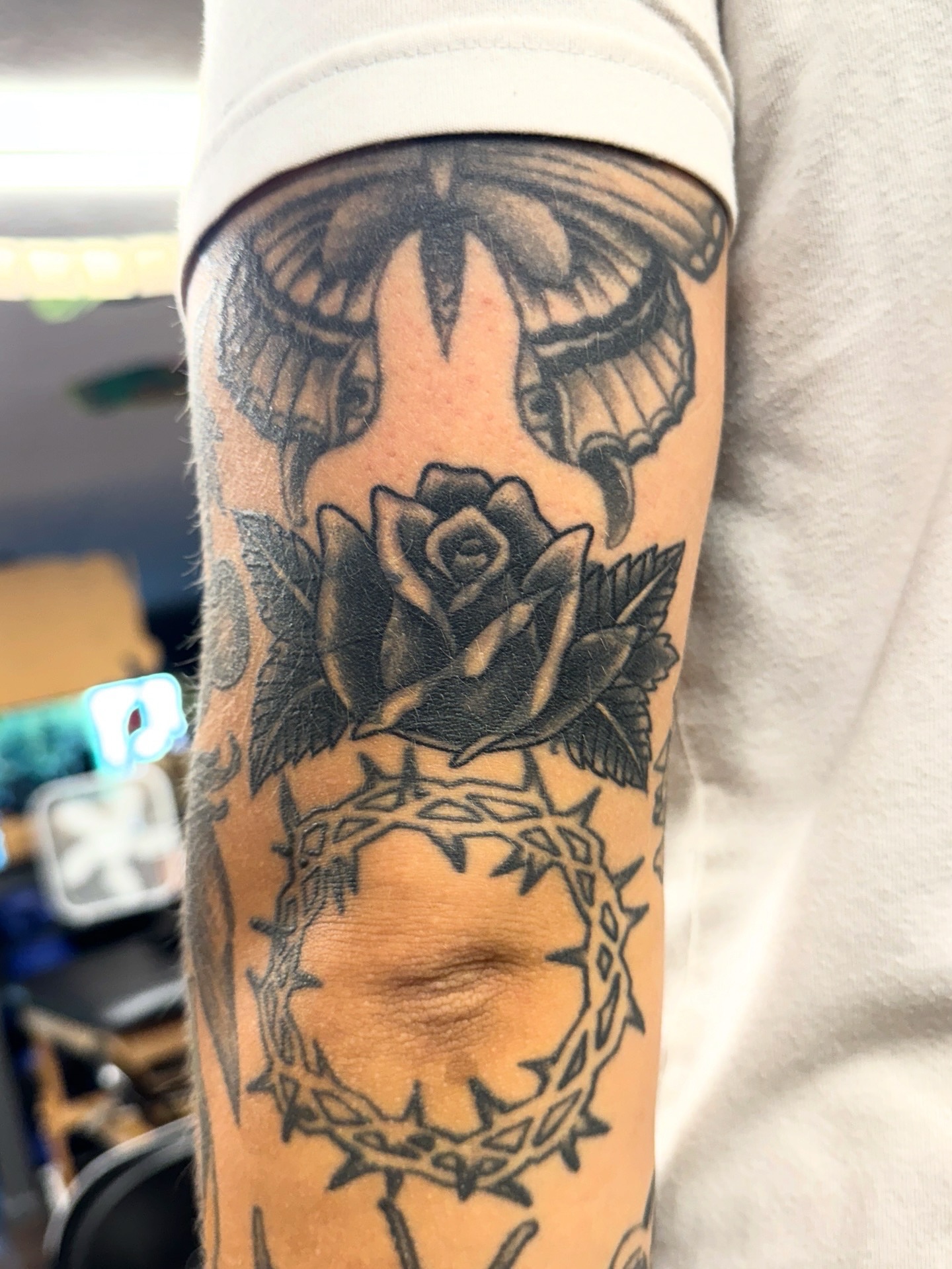 Rose and crown black and grey tattoo on the forearm by Sarah Pham