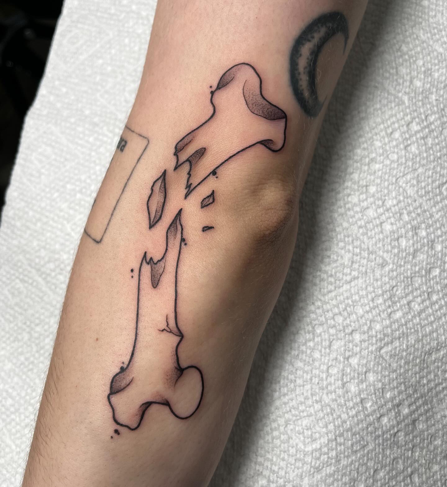 Bone black and grey tattoo on the forearm by Ty’s Tattoos