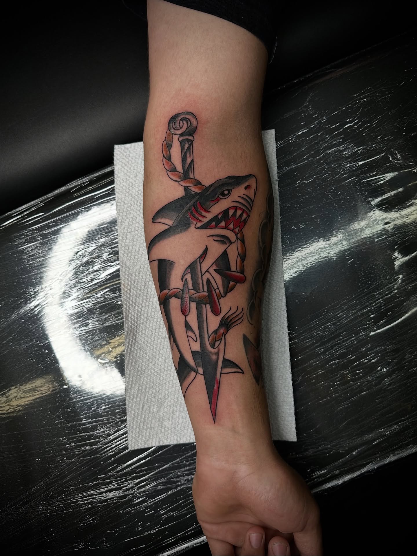 Shark and sword American traditional tattoo on the forearm by Leo Torres
