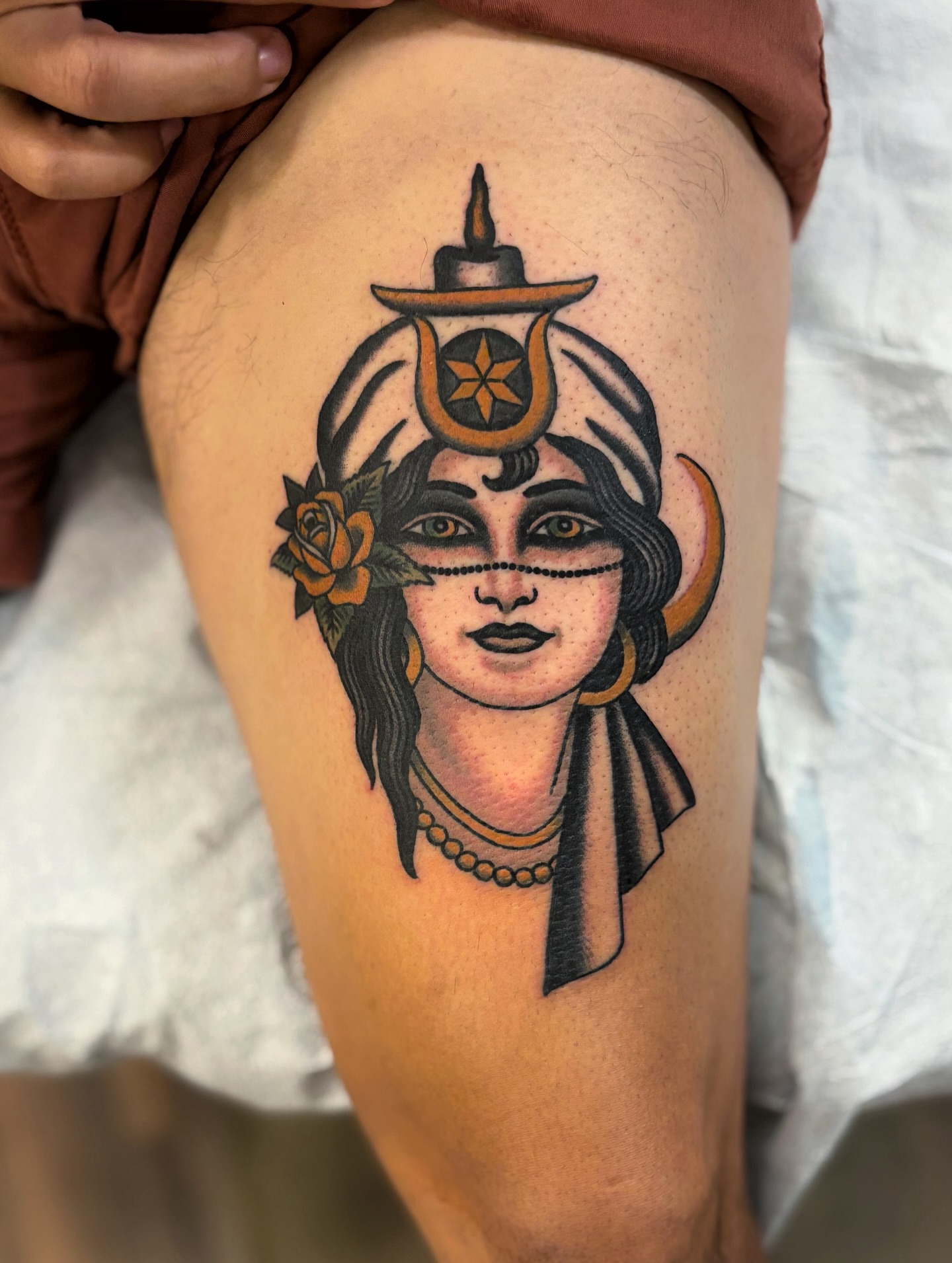 Woman with hat and flower American traditional tattoo on the thigh by Ben Fiedler