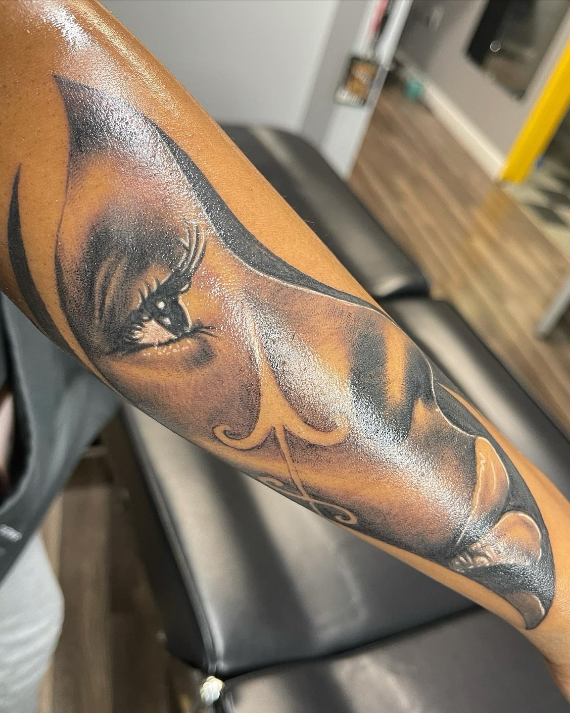 Eye and feather realism tattoo on the forearm by Ray Wiggins