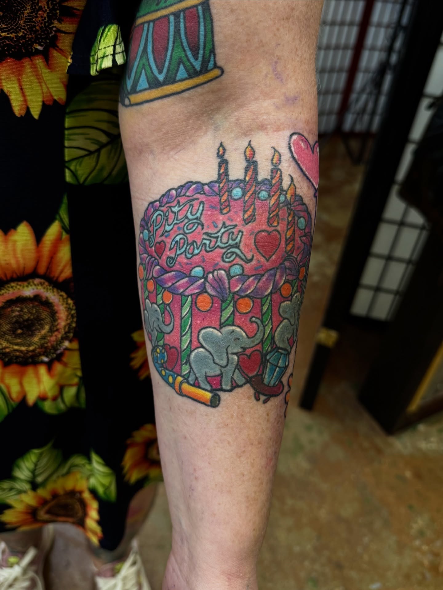 Birthday cake new school tattoo on the forearm by David C. McGhee
