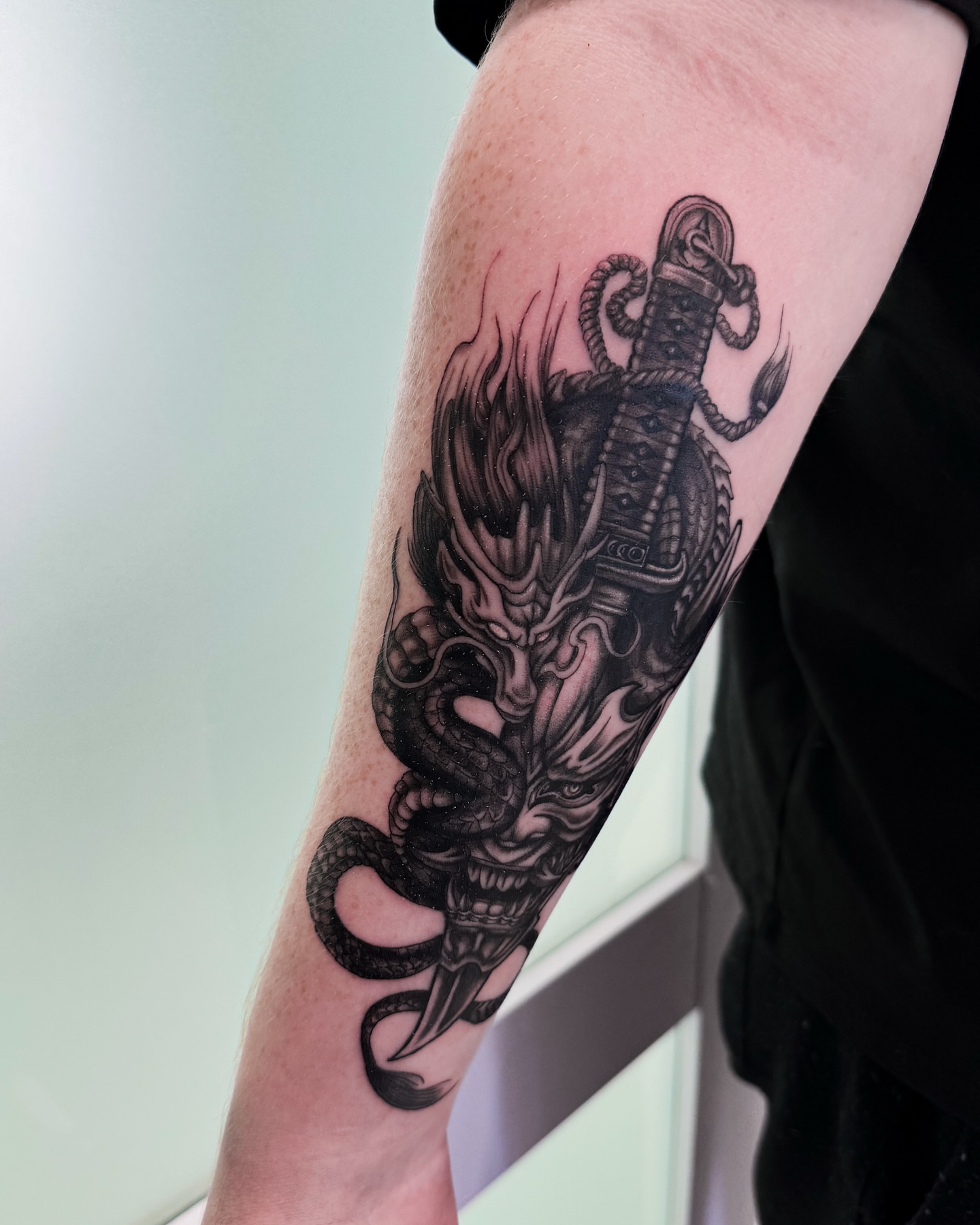 Demon mask with snake realism tattoo on the forearm by utah tattoo artist