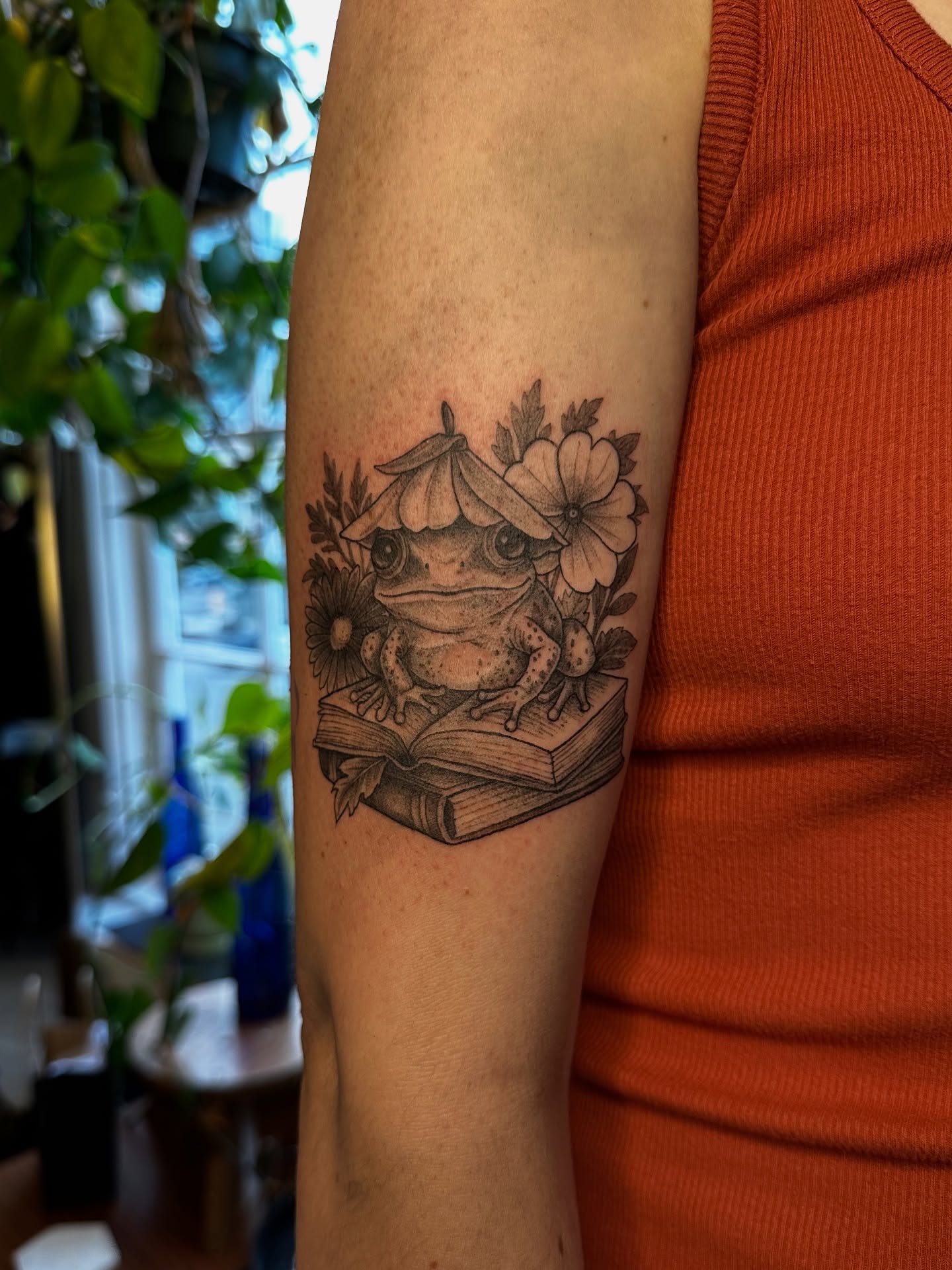 Frog reading book dotwork tattoo on the forearm by Emma Thompson