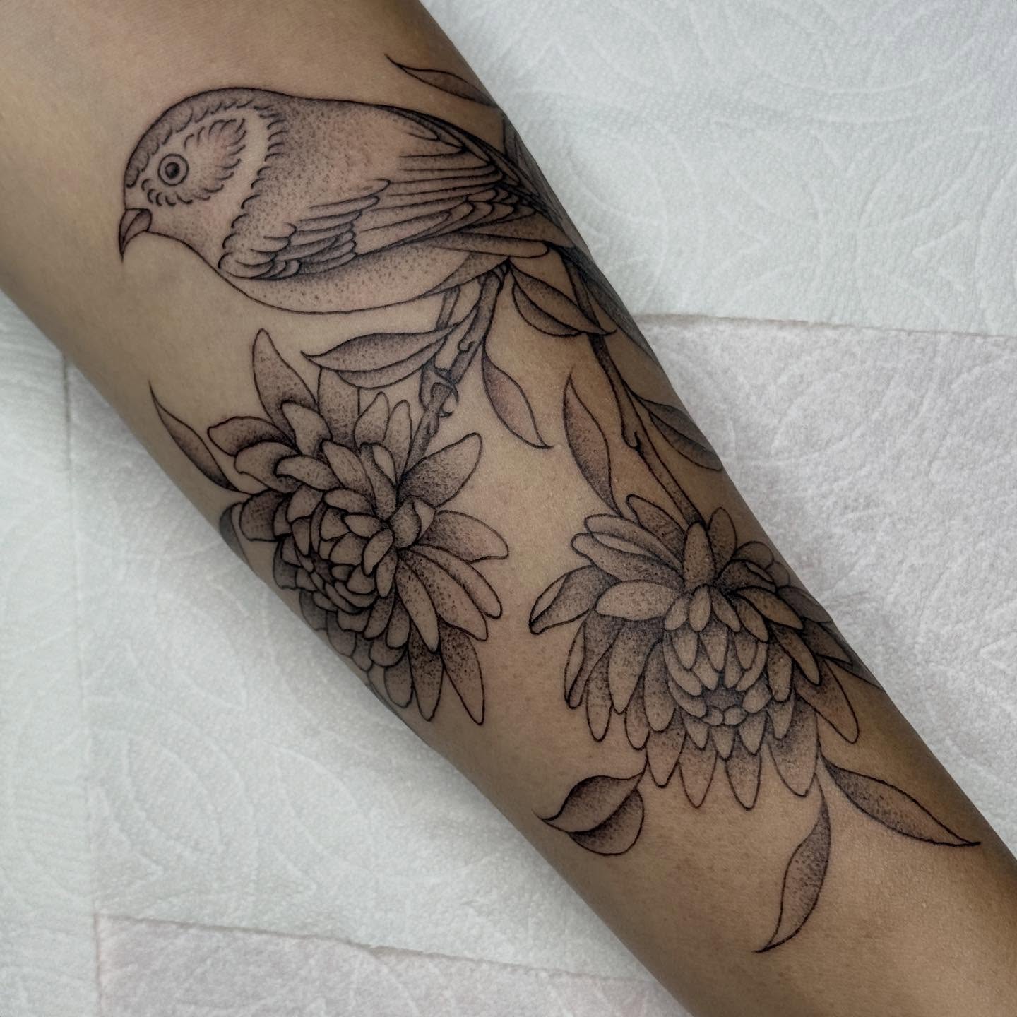 Bird and flowers dotwork tattoo on the forearm by chloe jeanel estrada