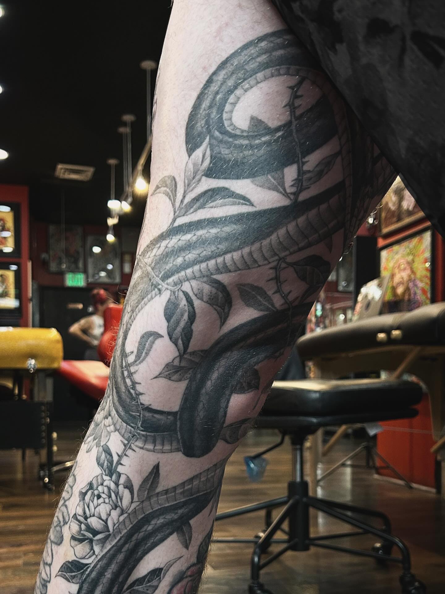 Snake and peony realism tattoo on the leg by Tako, Seattle, Washington