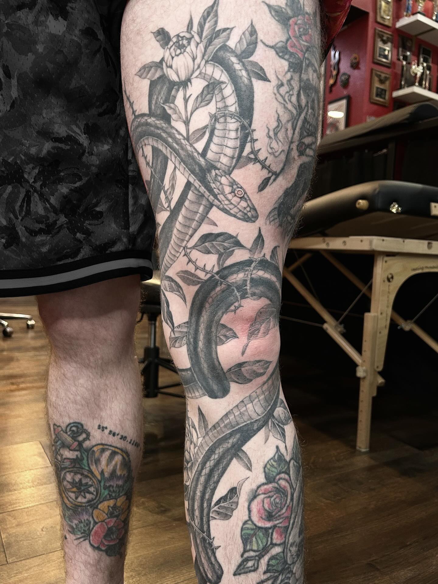 Snake and peony American traditional tattoo on the calf by Tako, Seattle, Washington