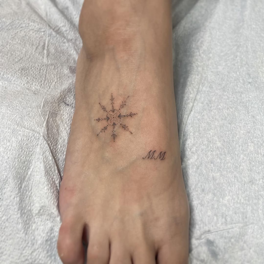 Snowflake and initials ornamental tattoo on the foot by Jesus A.