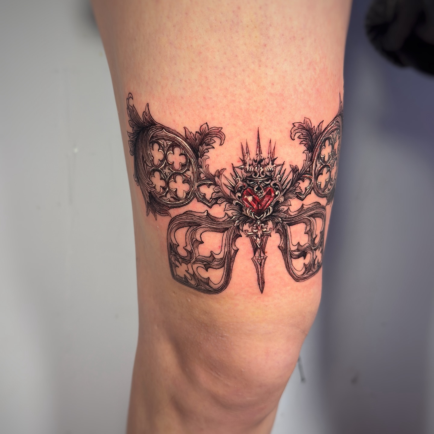 Mask ornamental tattoo on the leg by Jemin Ren