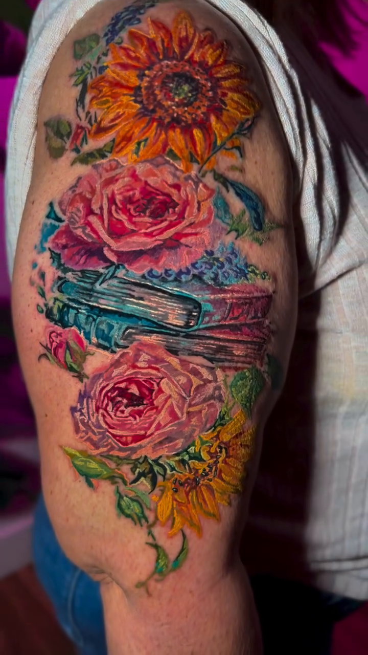Flowers and books realism tattoo by Colorful Tattoos by Cody Dean