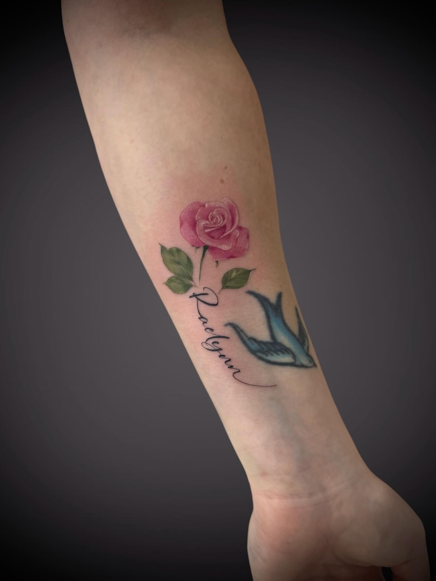 Rose and swallow realism tattoo on the forearm by Mitsuko Ching