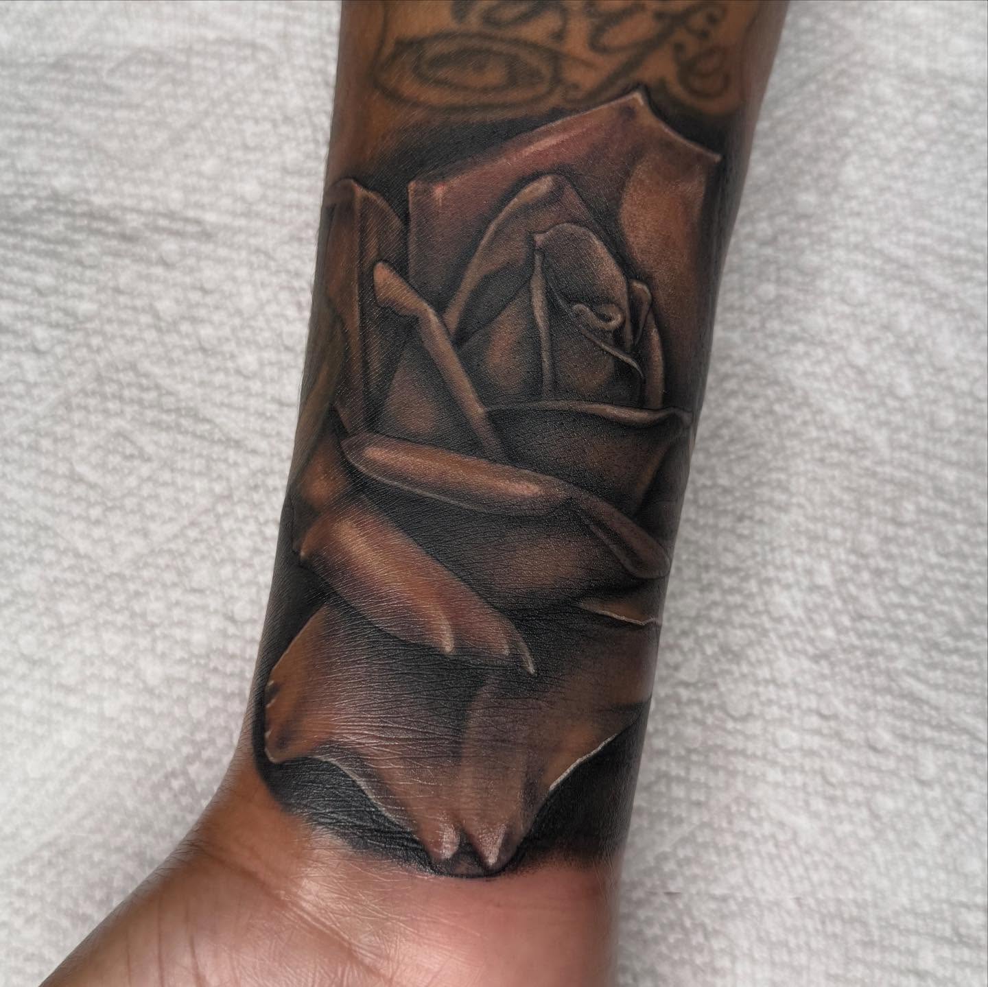 Rose dark realism tattoo on the forearm by Las Vegas Tattoo Artist