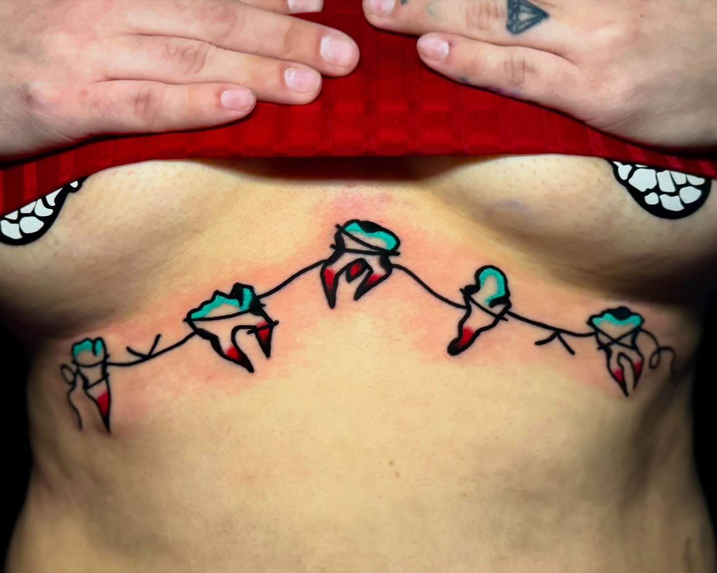 String of hearts American traditional tattoo on the chest by Javin Klingelhoefer Mosley