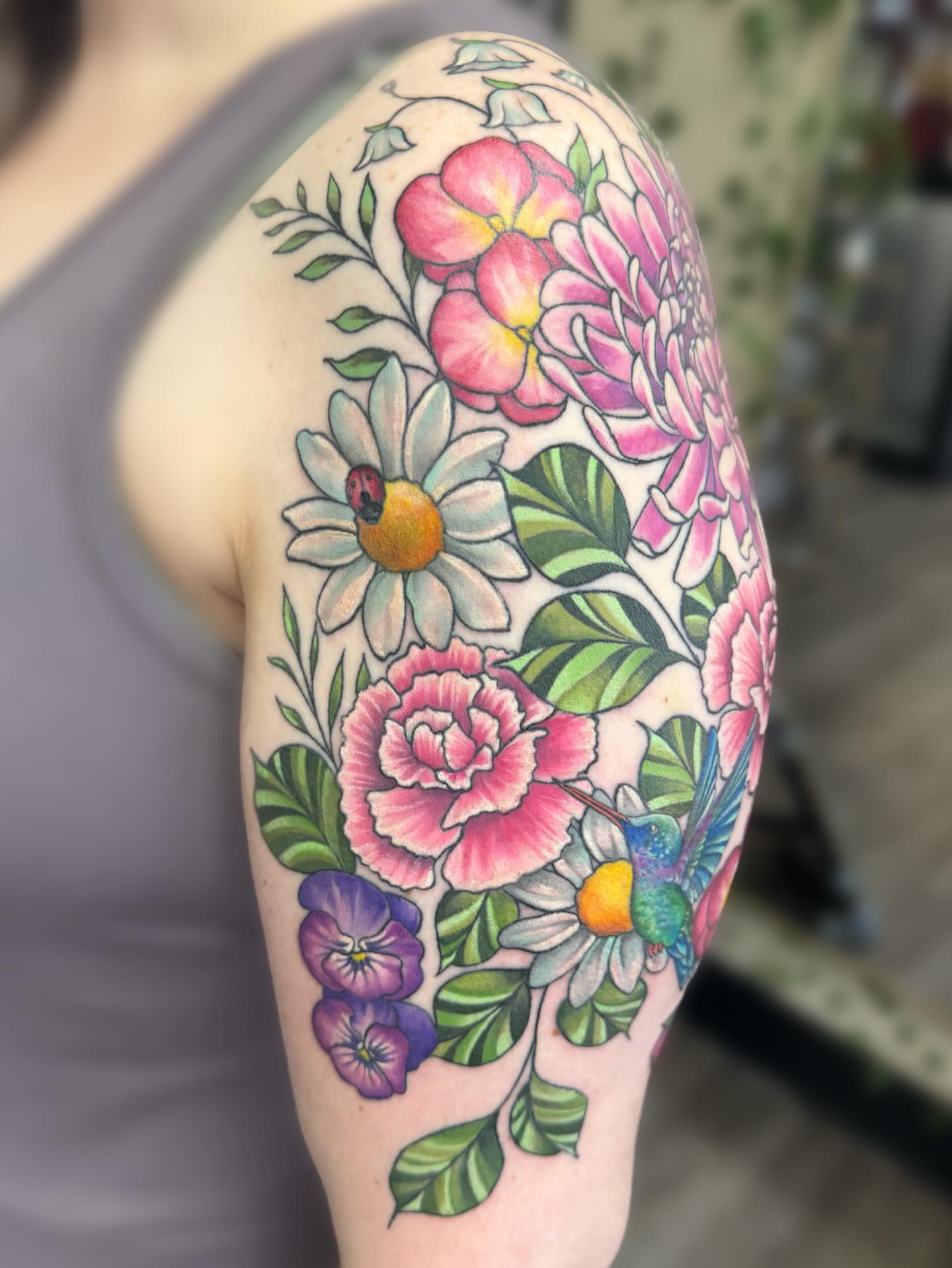Floral bouquet new school tattoo on the upper arm by Elly Bordwell