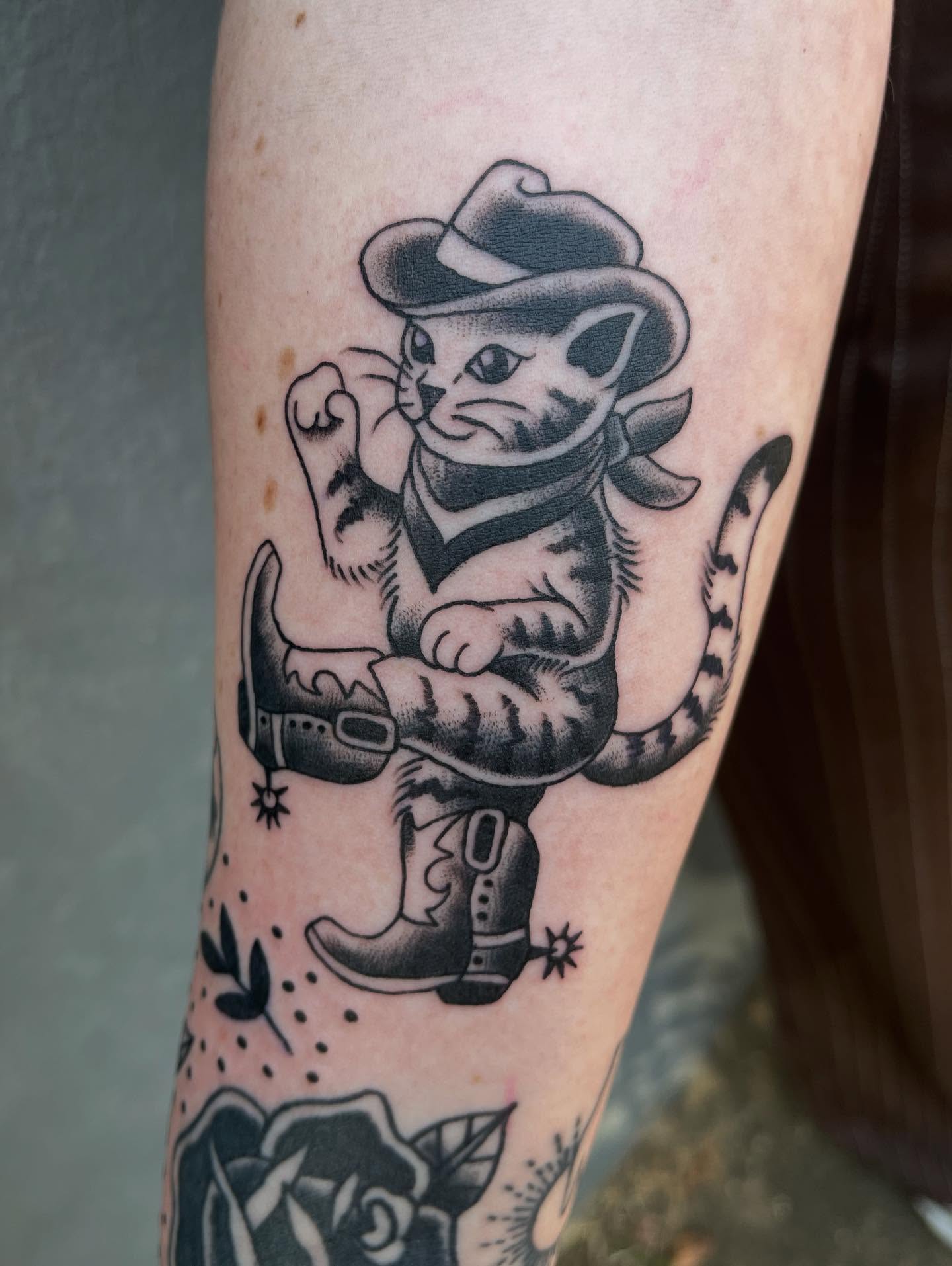 Cat cowboy American traditional tattoo on the forearm by Josh Brownell