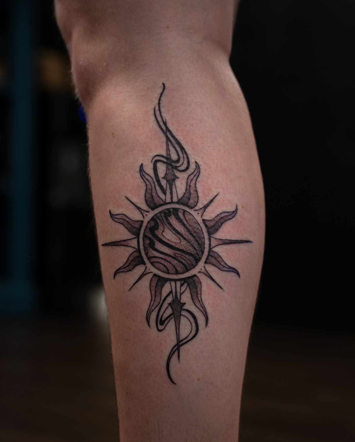 Sun black and grey tattoo on the forearm by Chris Estrada