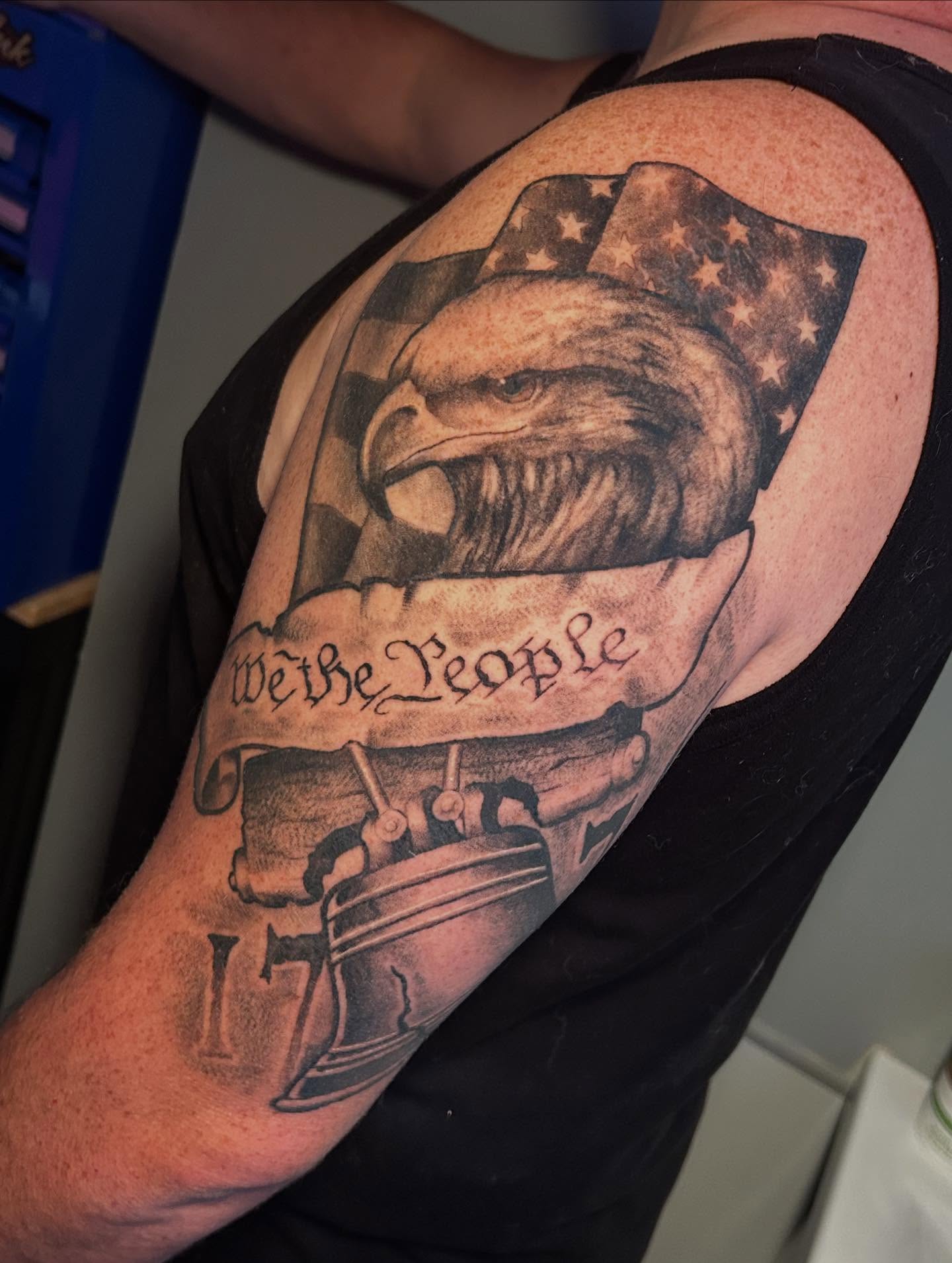 American eagle and flag American traditional tattoo on the shoulder by Adrian Michigan Tattoo Artist