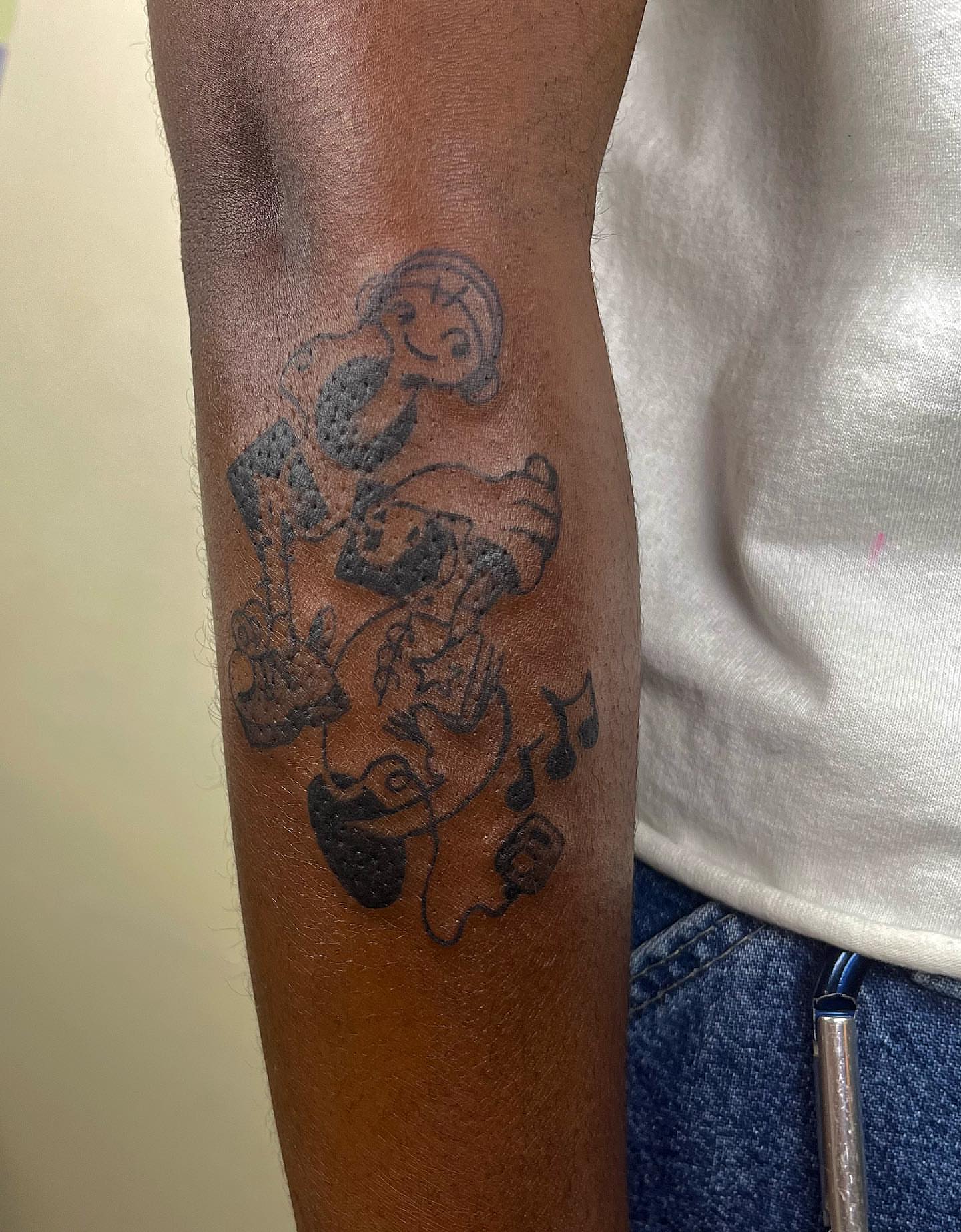 Musician playing guitar black and grey tattoo on the forearm by luce elias :