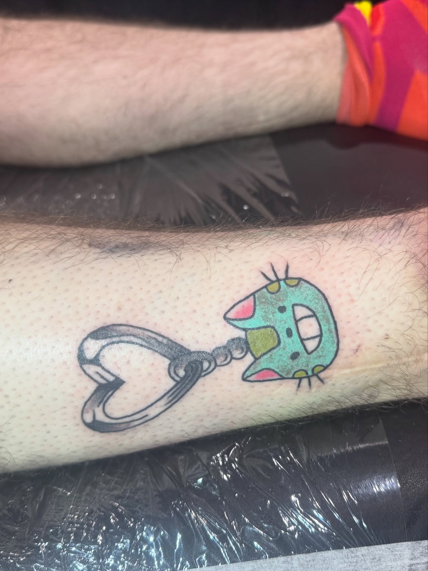 Cat with handcuffs dotwork tattoo on the forearm by 👾 not ur baby’s ink 👾