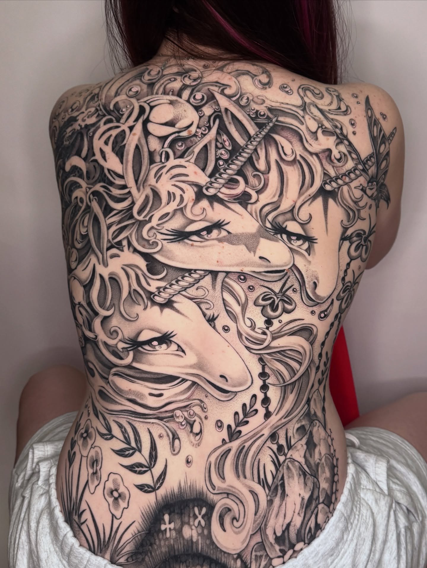 Unicorn and woman realism tattoo on the back by ella