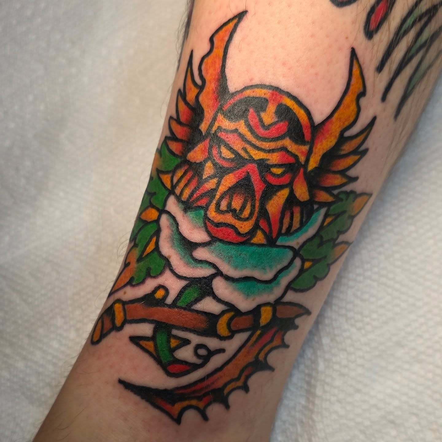 Skull and rose American traditional tattoo on the forearm by Mitch Braver