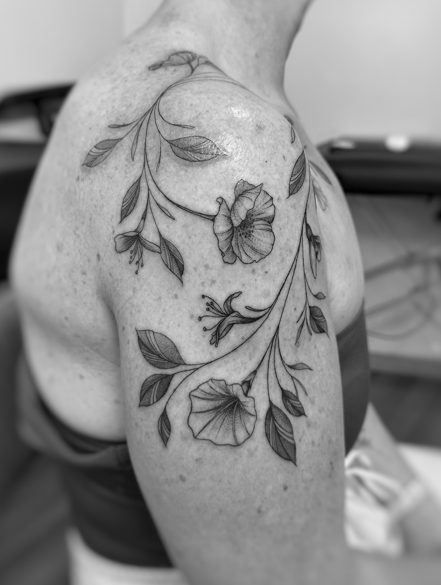 Floral design black and grey tattoo on the shoulder by jaclyn park