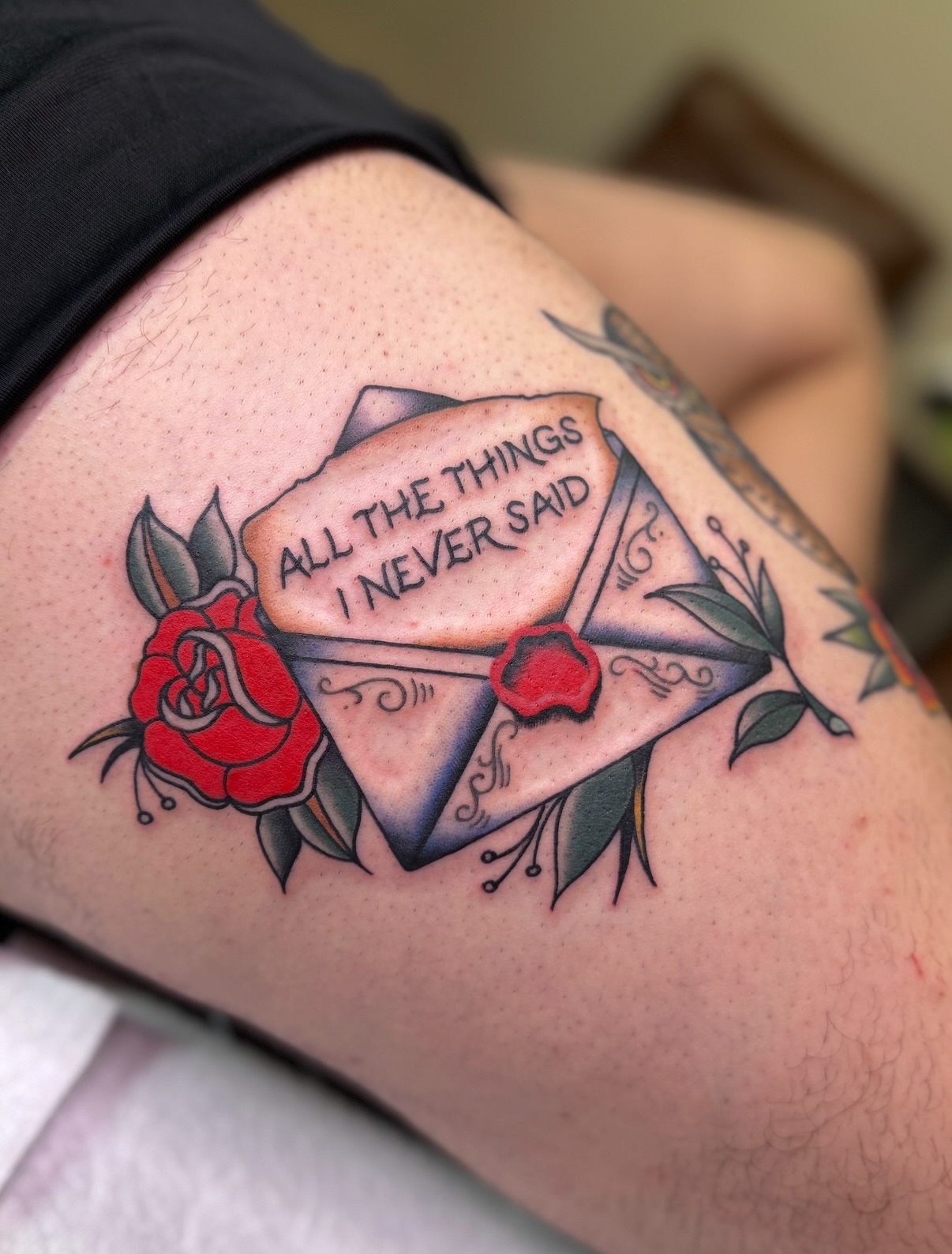 Letter with roses American traditional tattoo on the thigh by Ethan, Toledo, Ohio