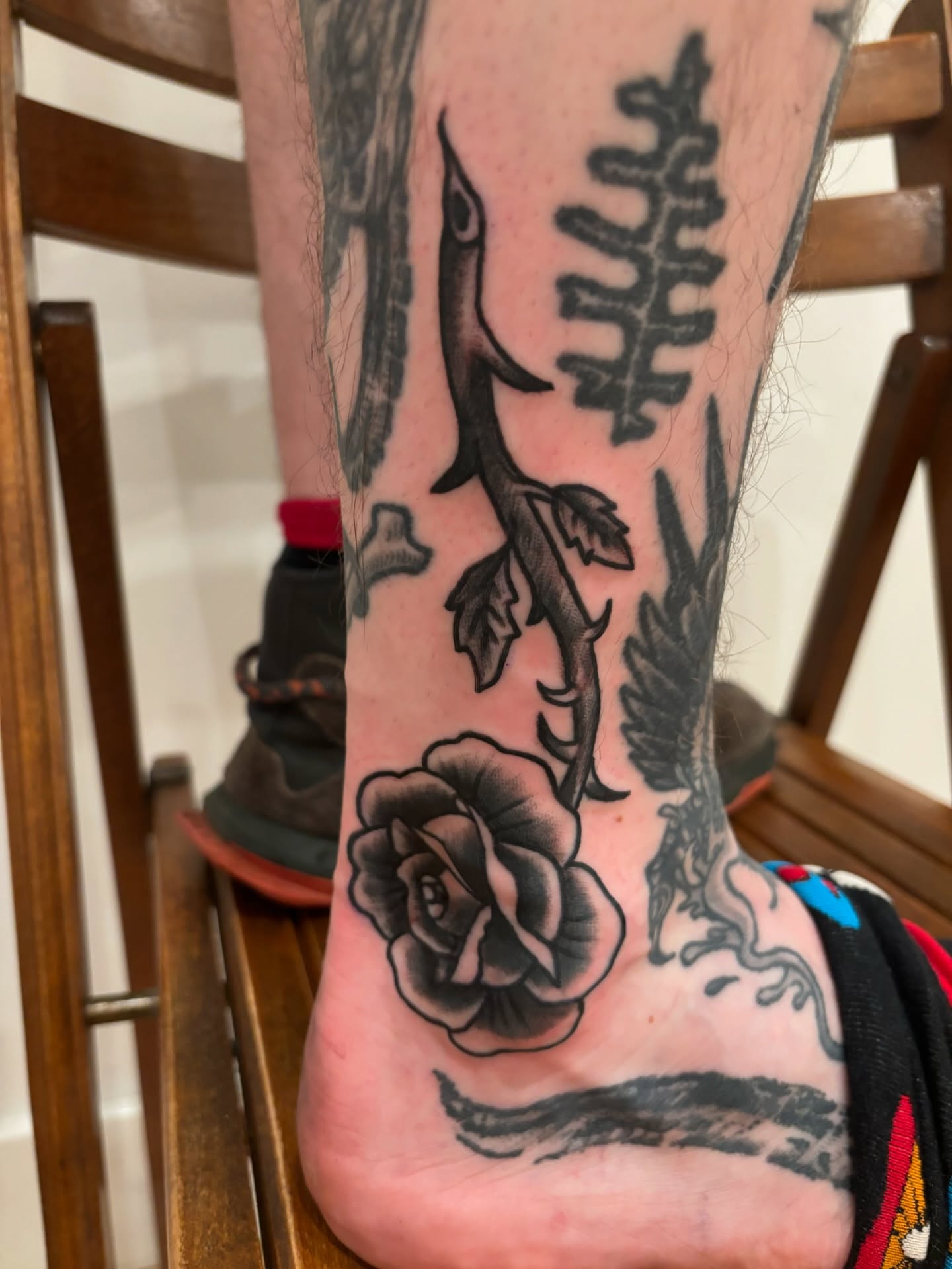 Rose and bird black and grey tattoo on the forearm by Francis Cassidy