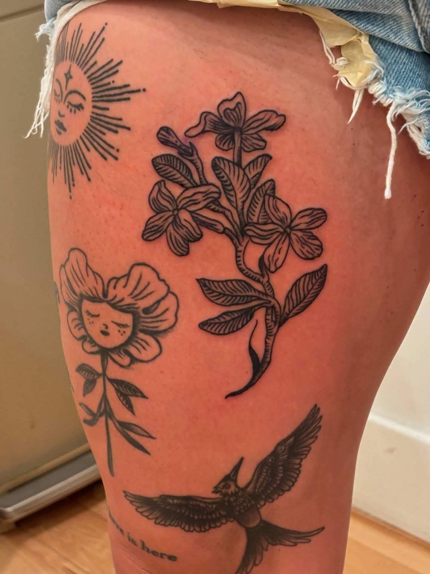 Floral and bird black and grey tattoo on the thigh by Francis Cassidy