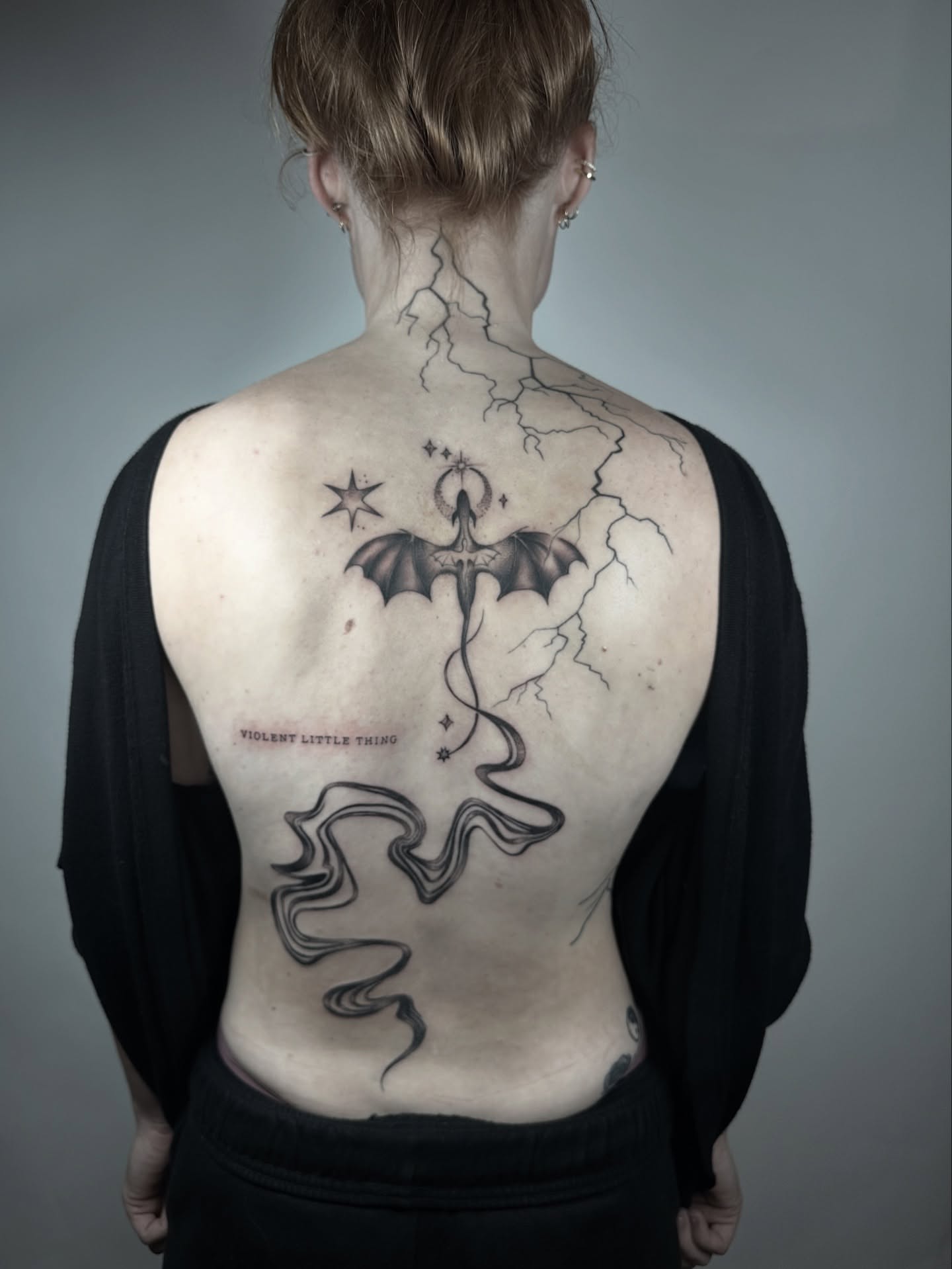 Bat and lightning black and grey tattoo on the back by Heather Cherish