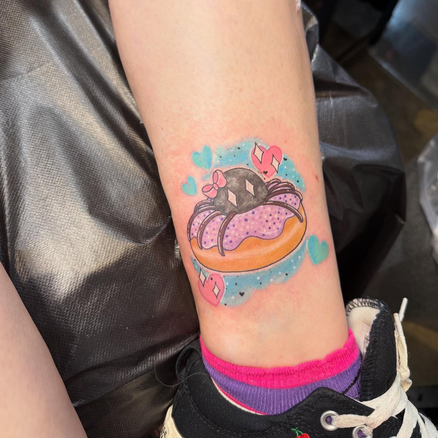 Donut with spider dotwork tattoo on the forearm by Brandie Caroline, Somers Point, New Jersey
