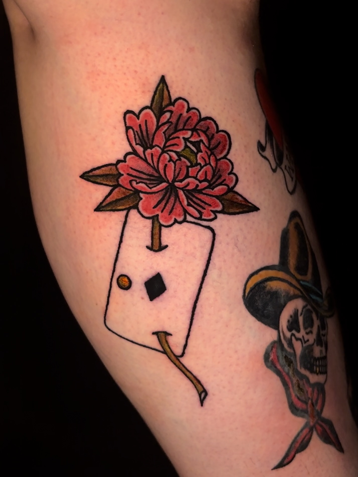 Flower and playing card American traditional tattoo on the thigh by Rachel