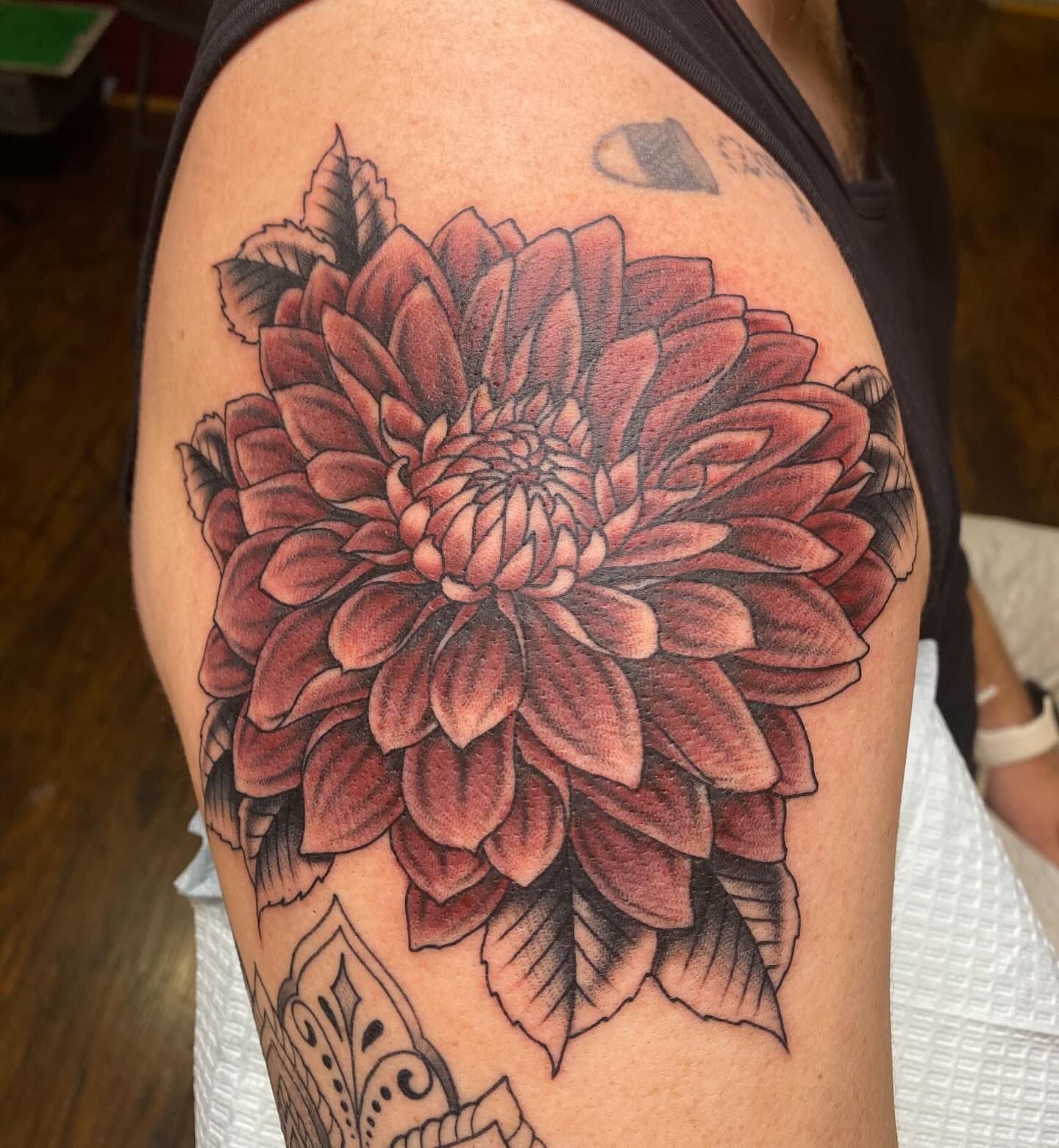 Dahlia flower realism tattoo on the shoulder by Thomas Cook