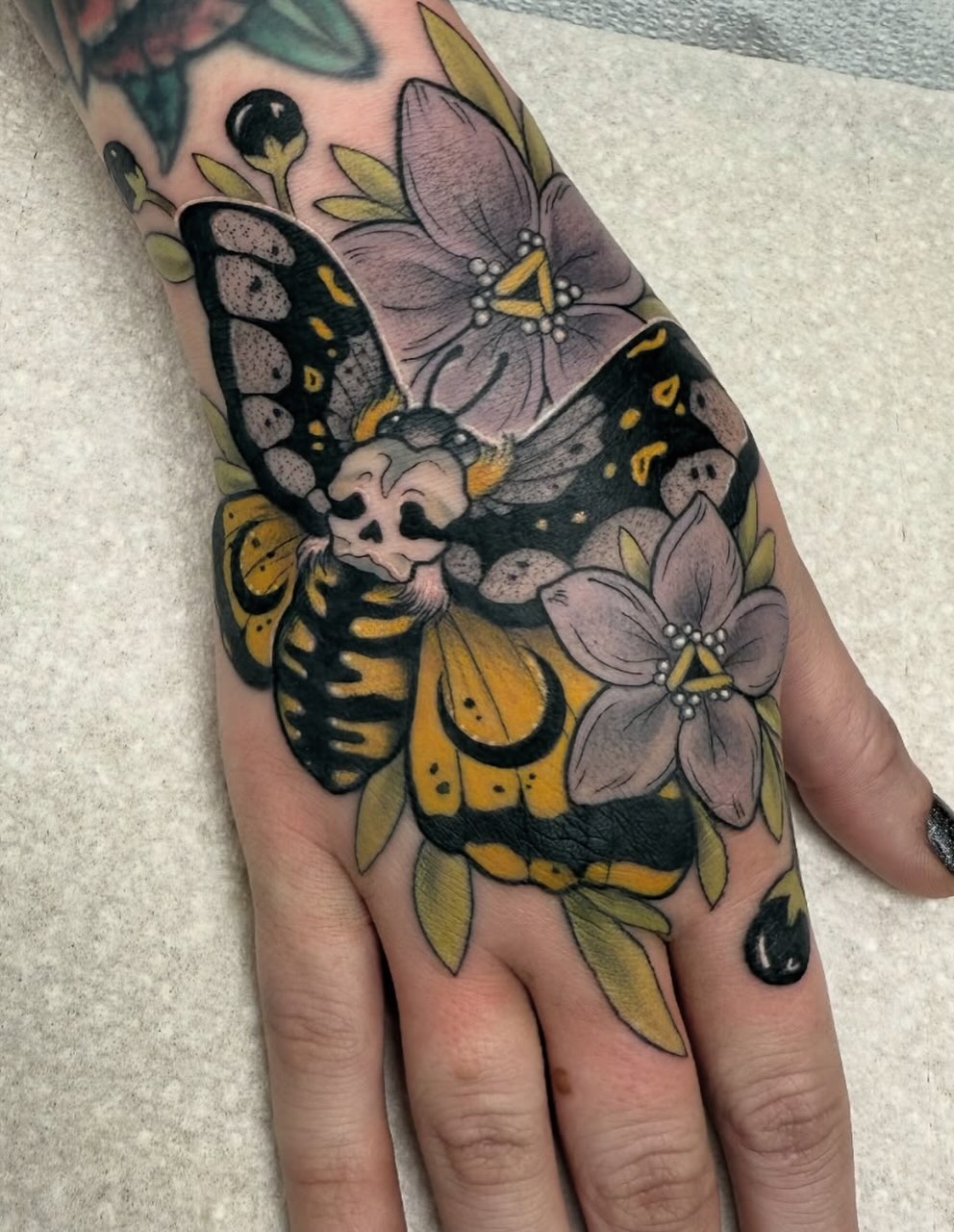 Butterfly and flowers American traditional tattoo on the hand by Maia Papaya Tattoos 🐝 Olympia Tattoo Artist