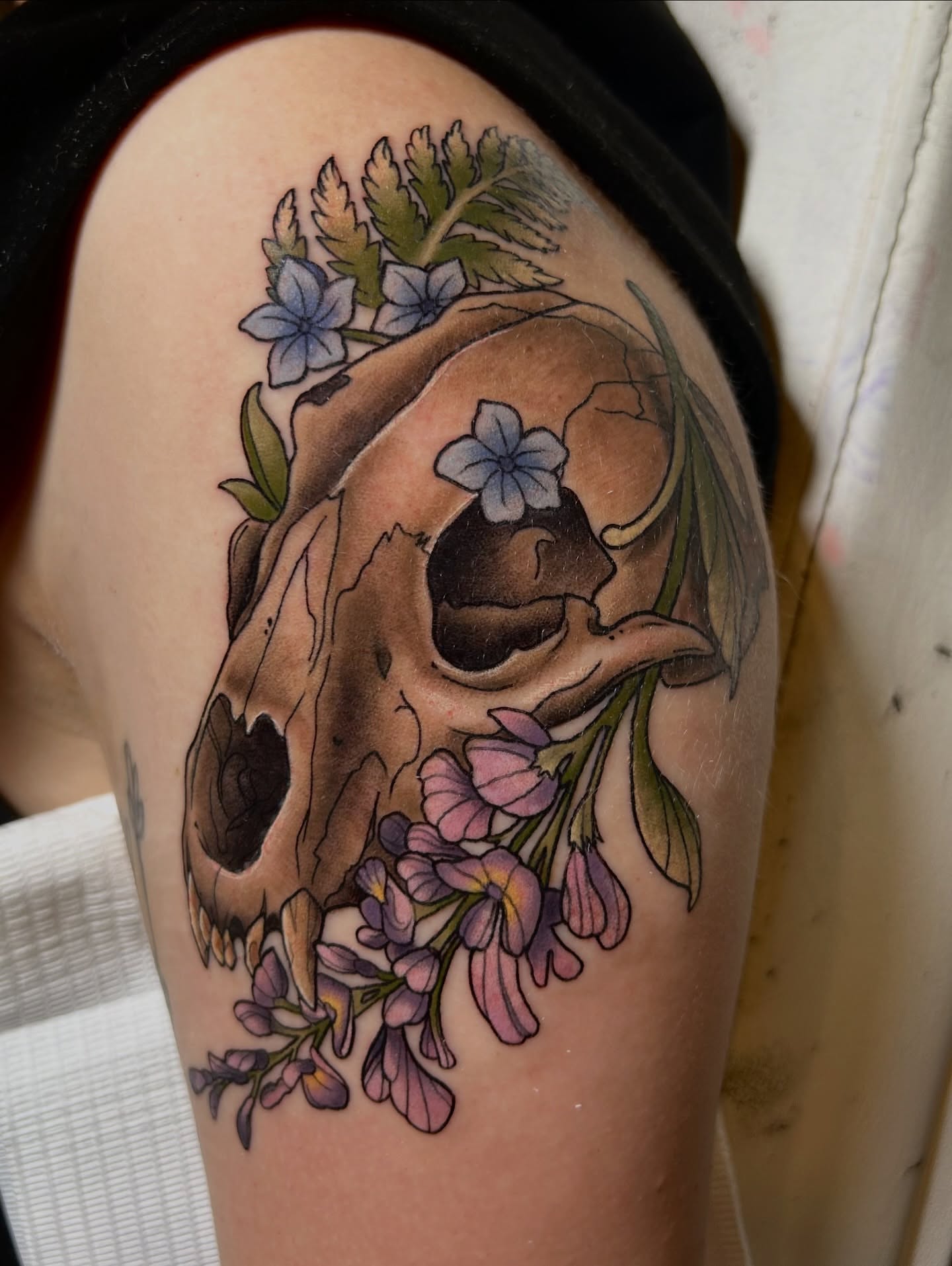 Skull with flowers realism tattoo on the shoulder by Tattoos By Lola Cavotta, Willoughby, Ohio