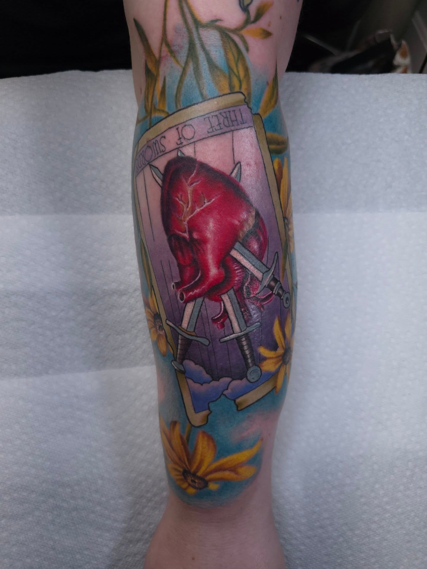 Pig and flowers realism tattoo on the forearm by Dick Eckman