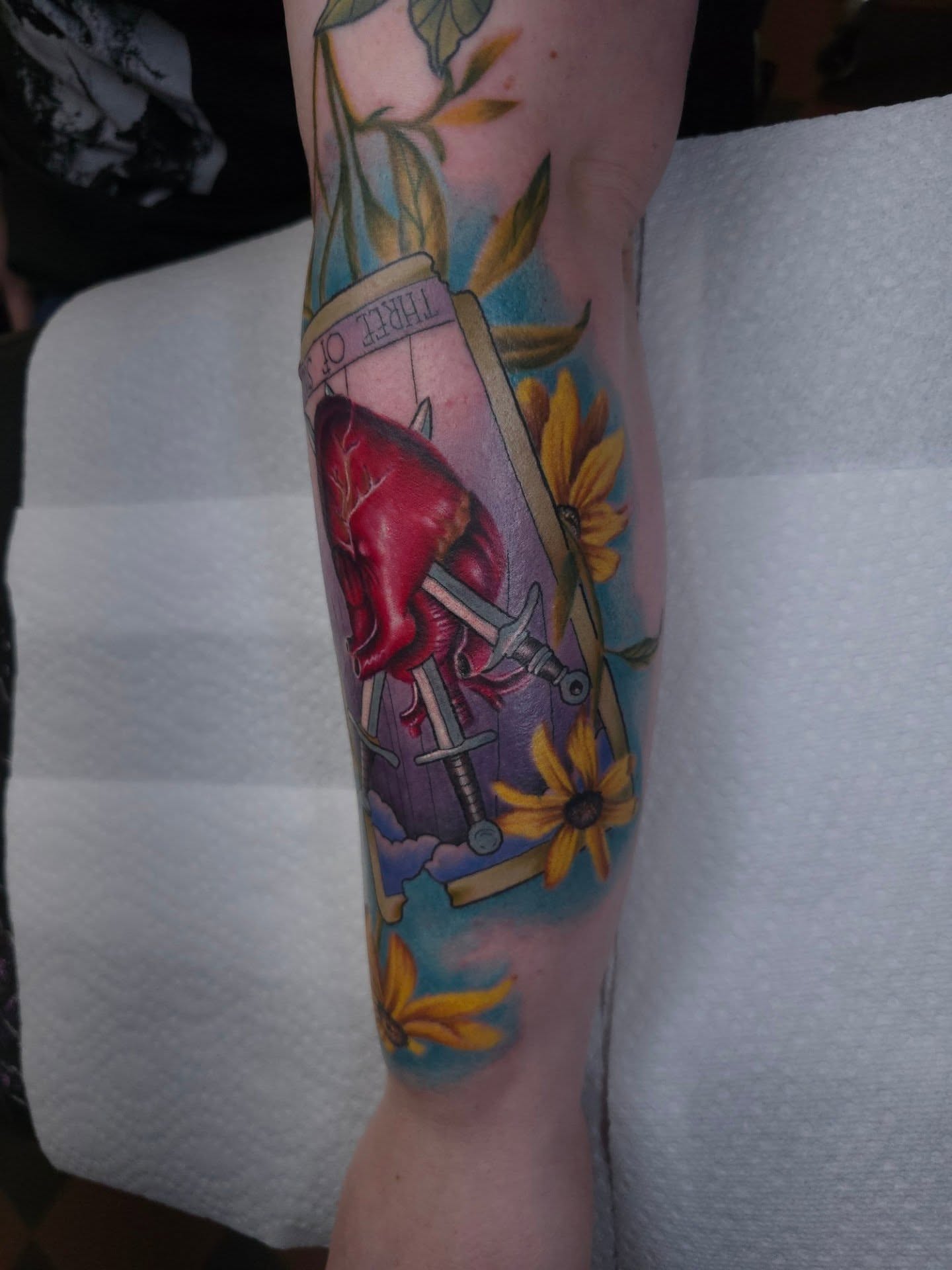 Heart and swords American traditional tattoo on the forearm by Dick Eckman