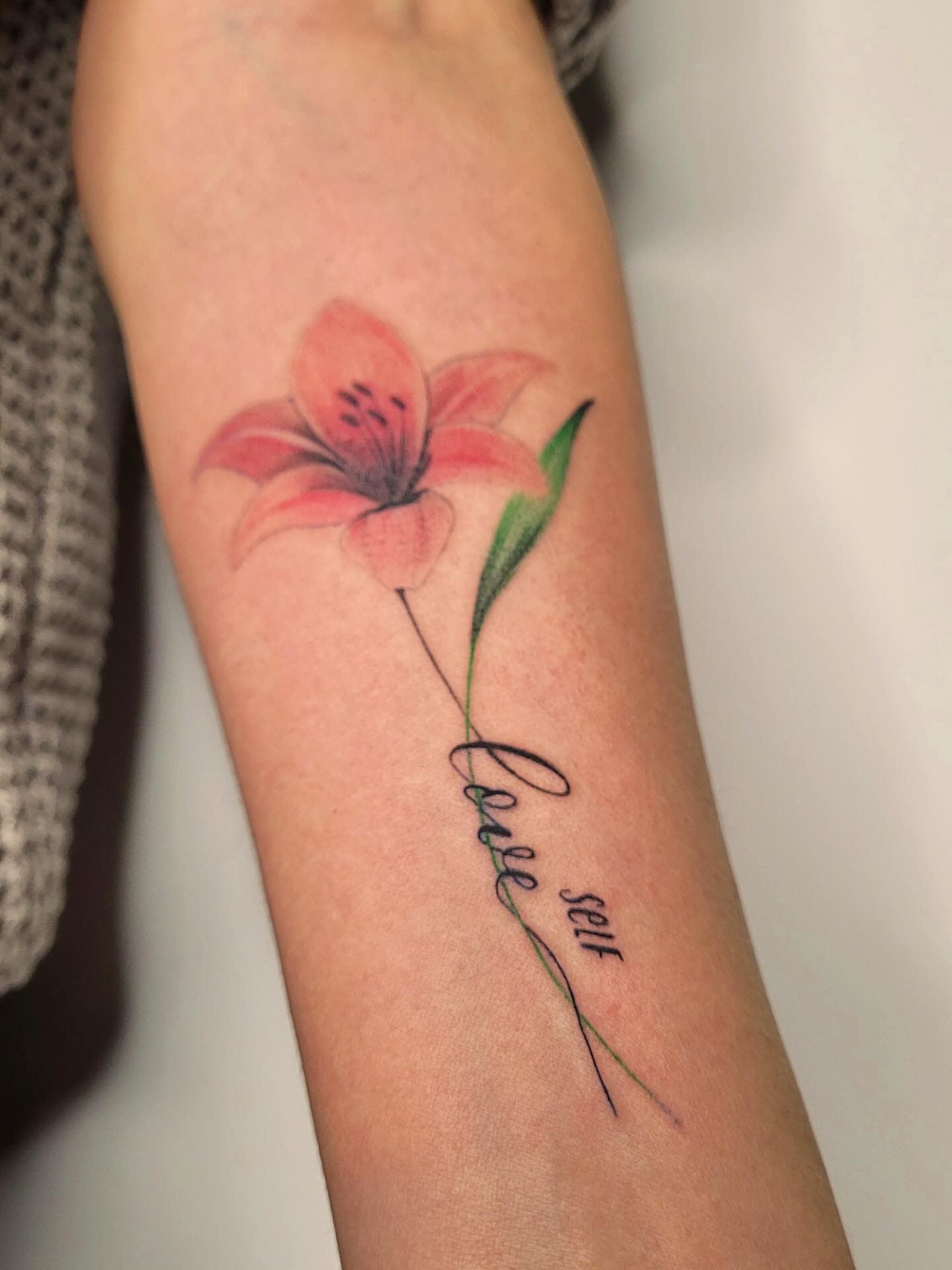 Lily realism tattoo on the forearm by Артем Летний