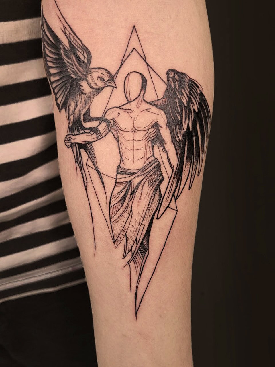 Angelic figure with bird realism tattoo on the forearm by Артем Летний
