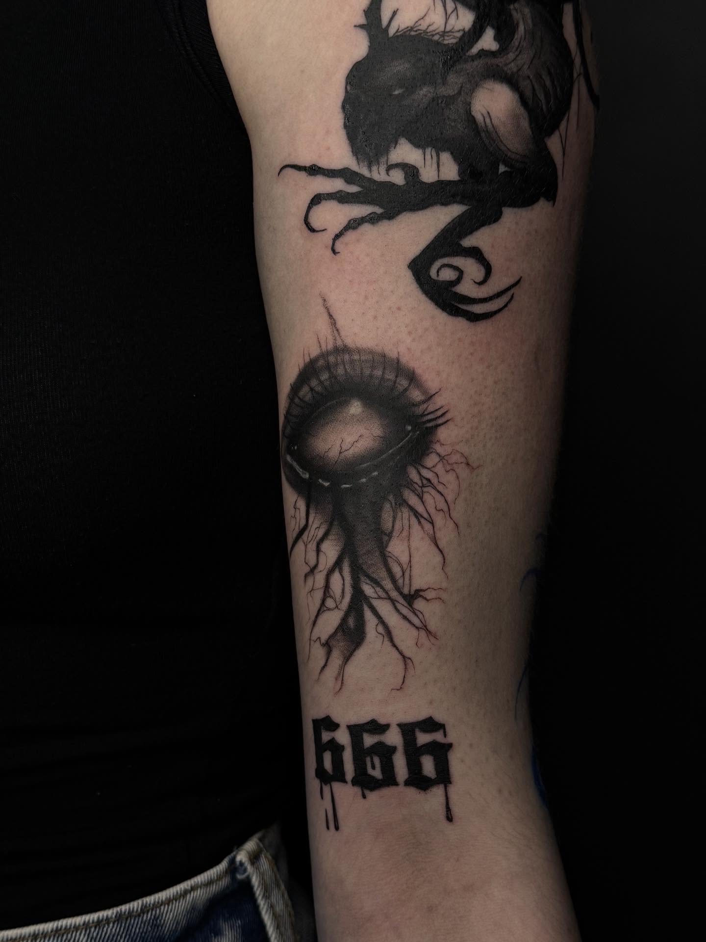 Eye with roots realism tattoo on the forearm by Артем Летний