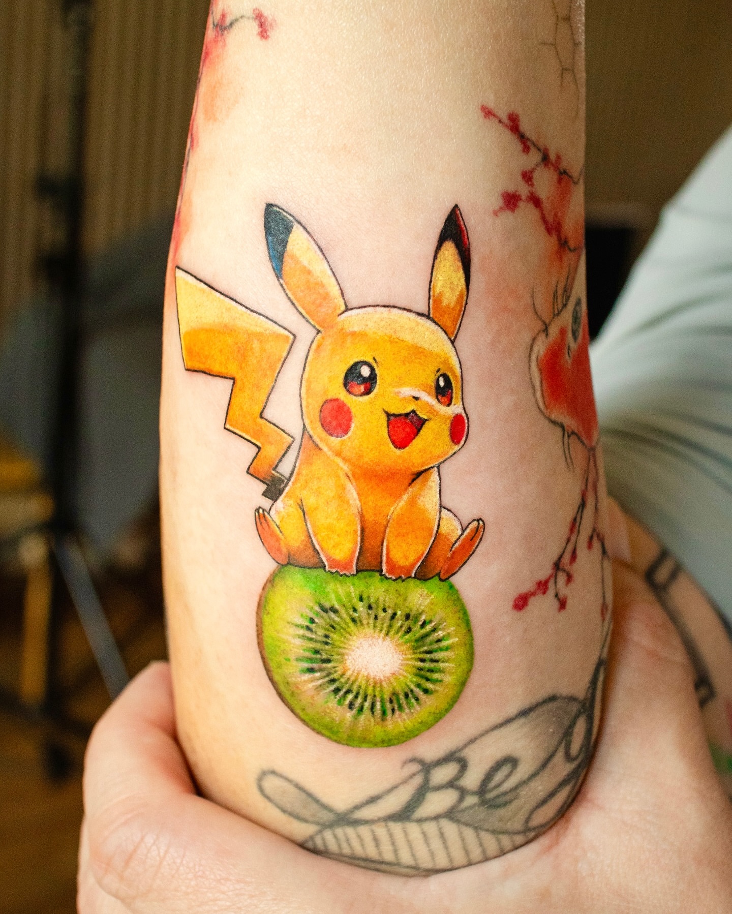 Pikachu on kiwi new school tattoo on the forearm by YUN